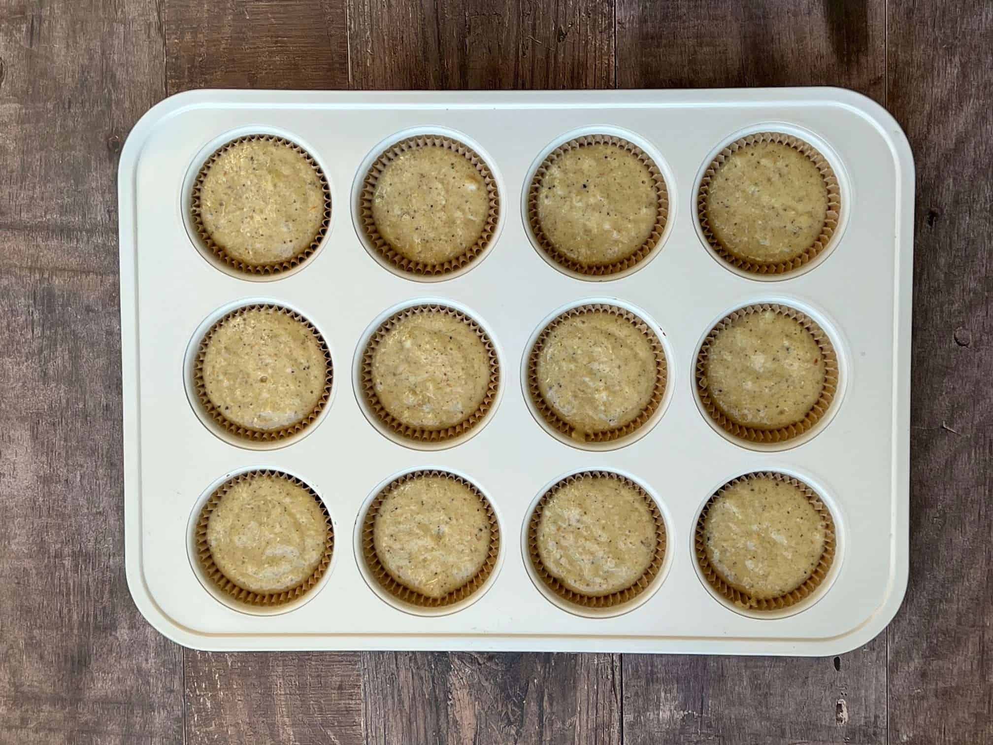 banana cardamom muffin batter in tins