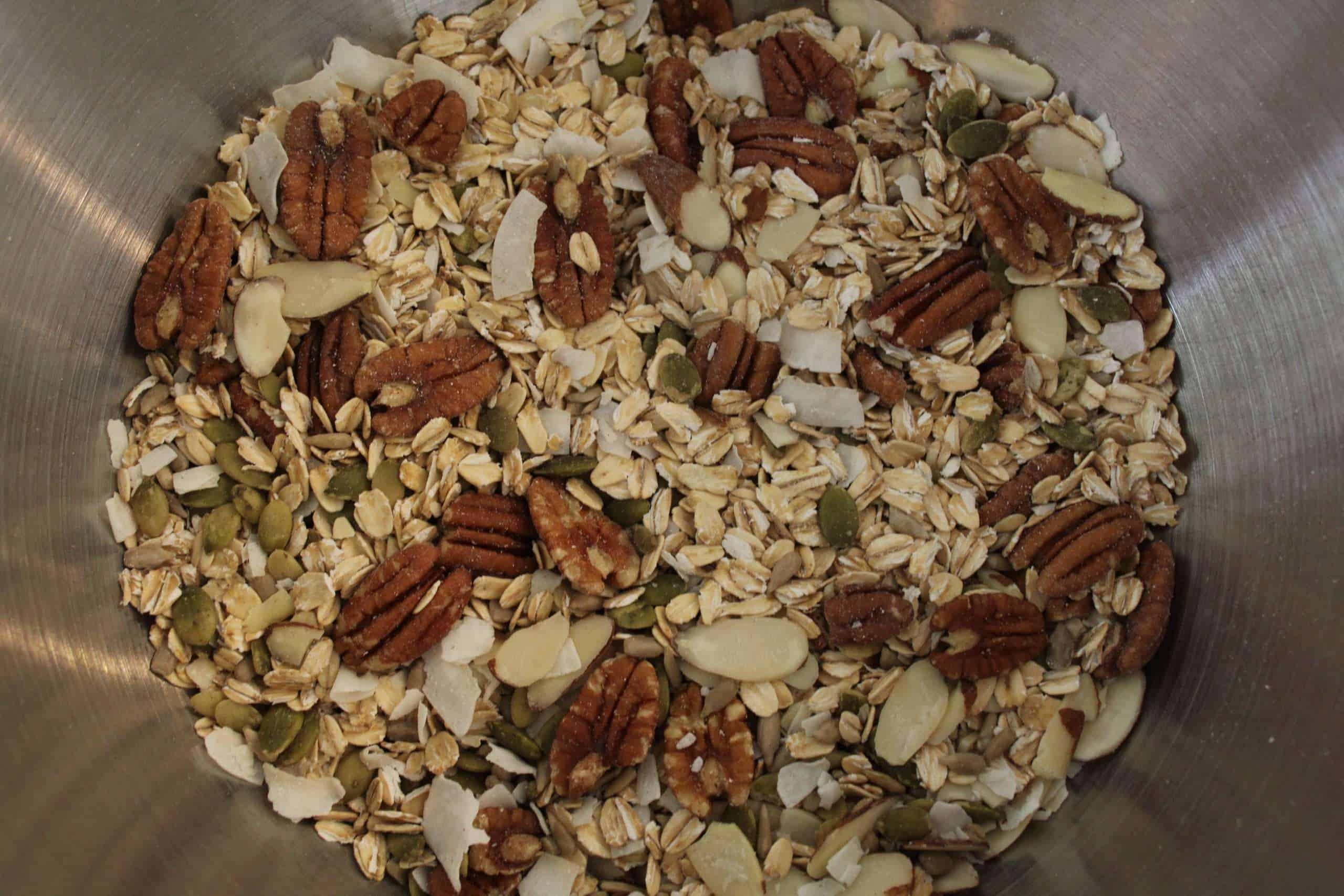 granola step 1 Bowl with oats, nuts, seeds and coconut flakes for granola
