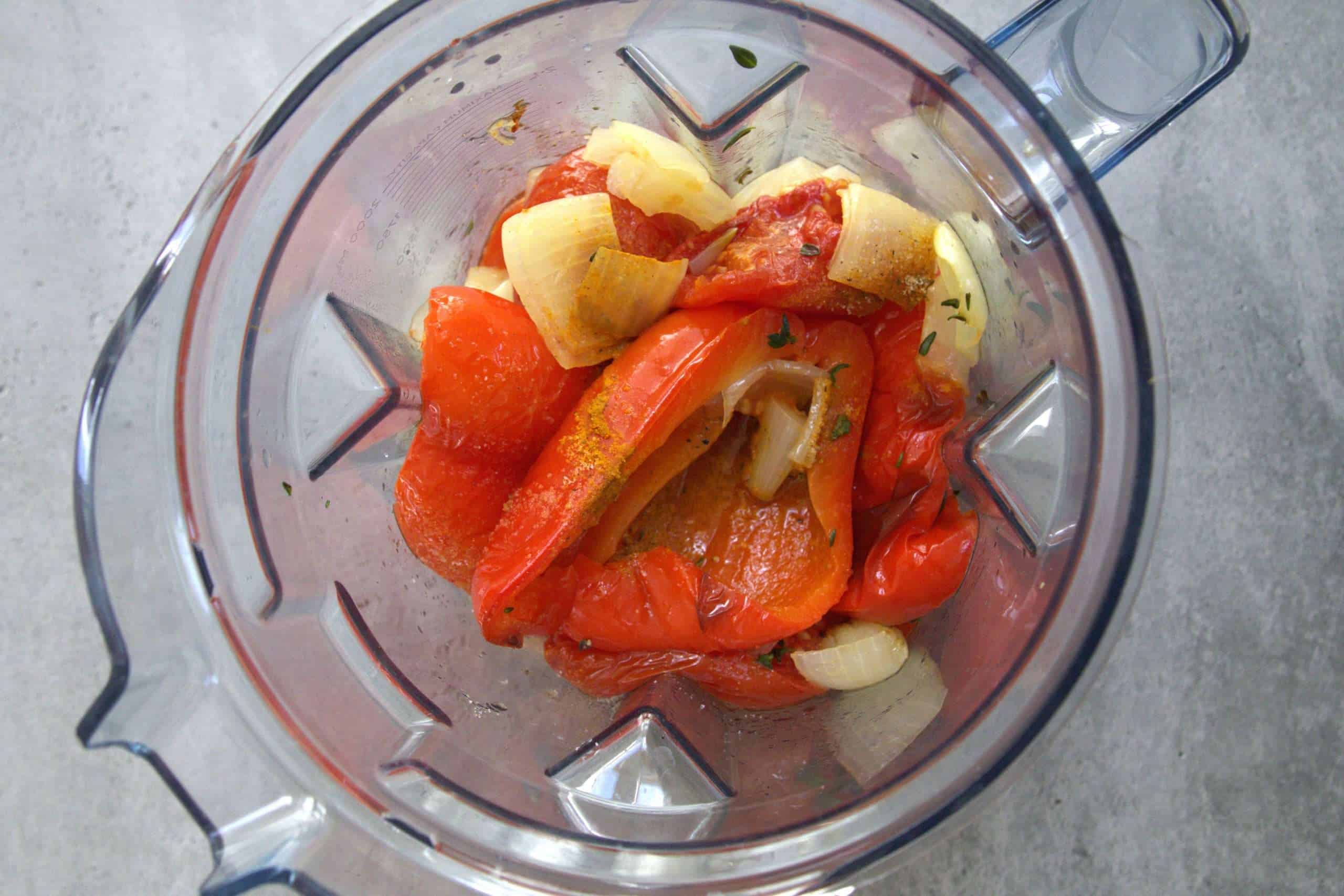Ingredients for roasted tomato and bell pepper soup in a blender, ready to be blended