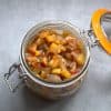 an open jar filled with apple chutney