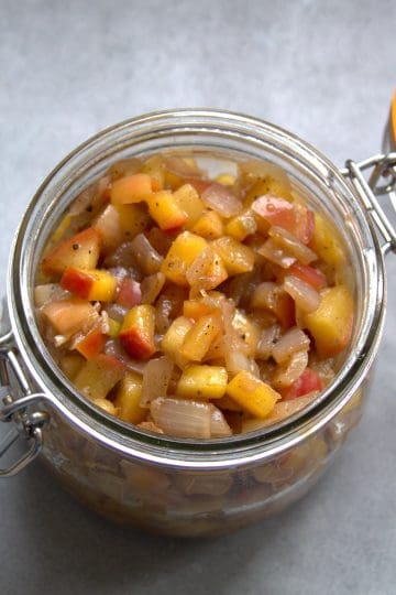 an open jar filled with apple chutney