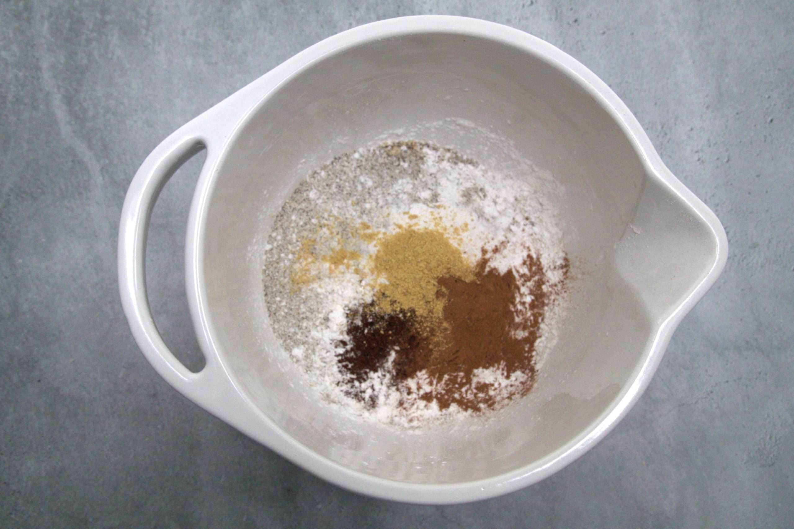 dry ingredients for hazelnut apple coffee cake in a white mixing bowl