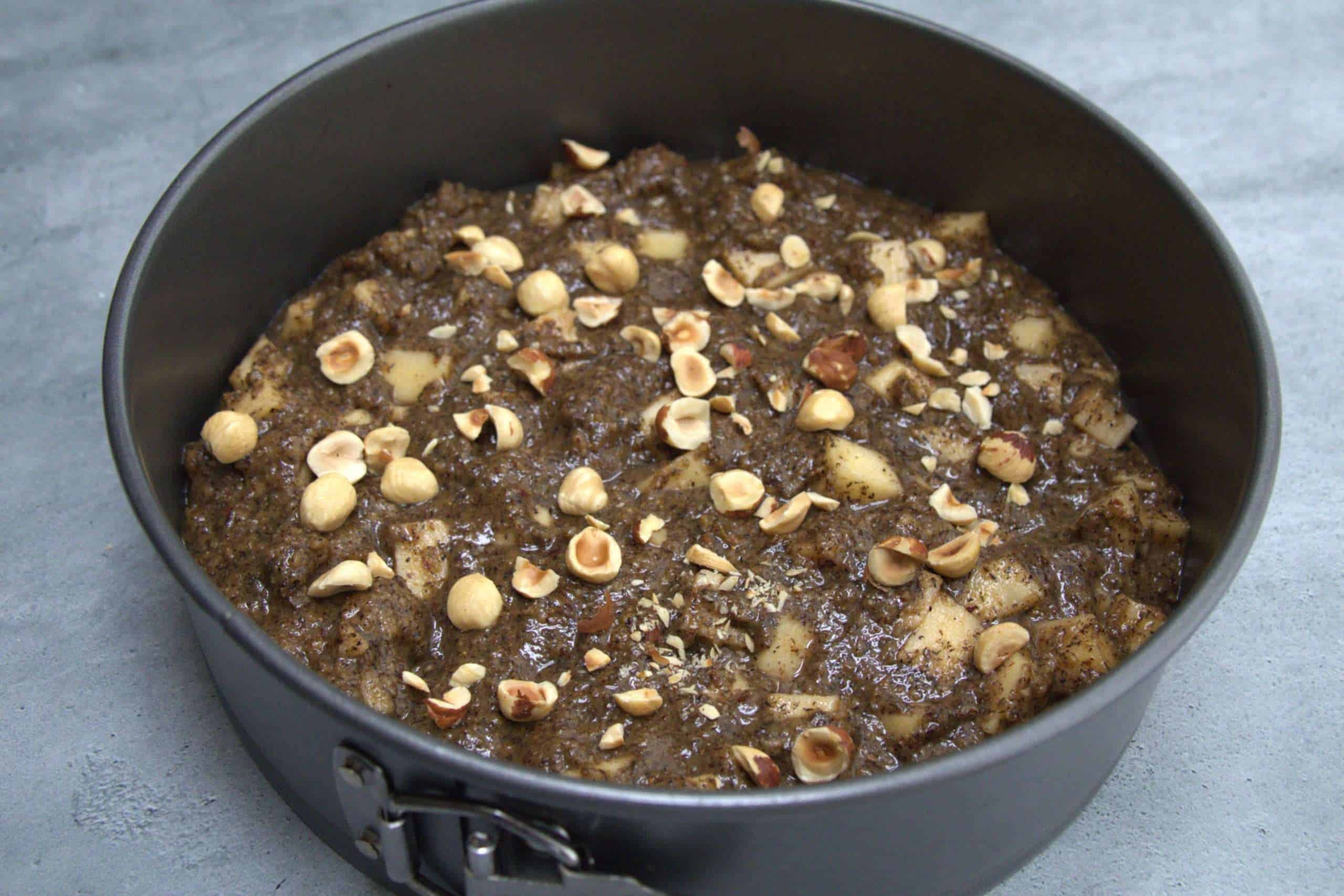 Hazelnut apple coffee cake in a springform pan, ready to bake