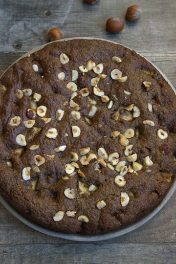 hazelnut and apple coffee cake with a knife and napkin resting next to it