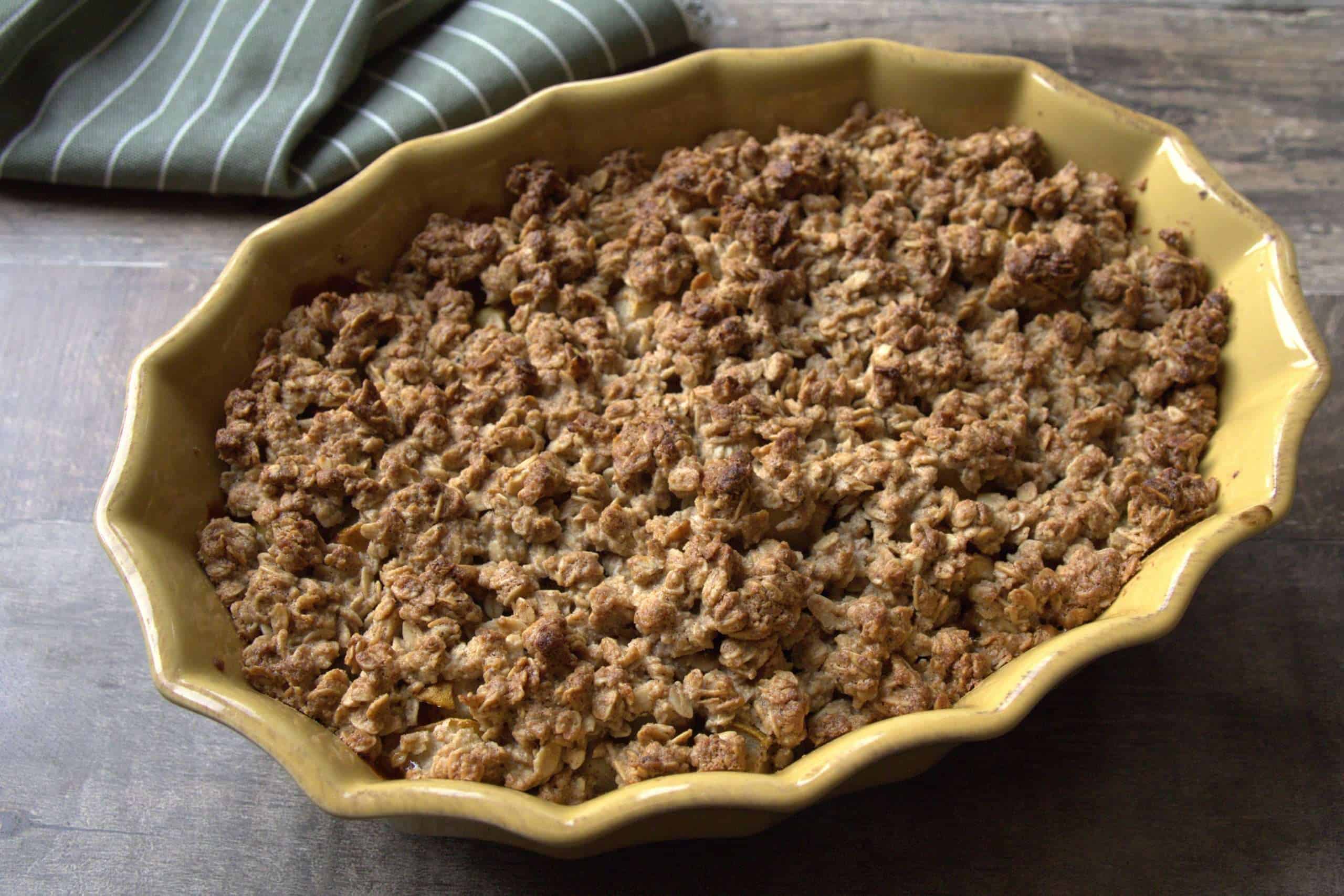 pear crumble5 A baking dish with pear crisp and a green and white striped napkin in the background