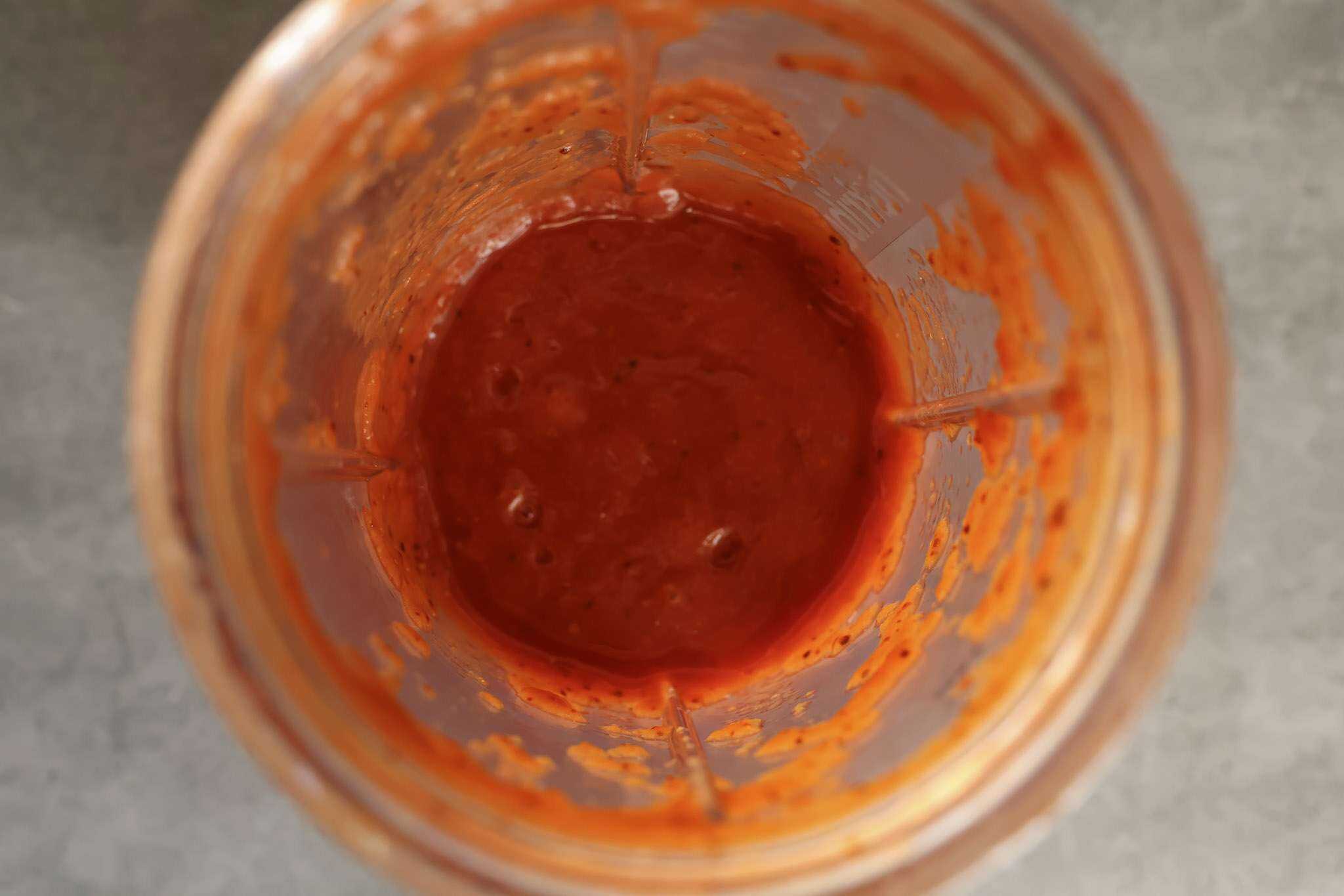 blended diced tomatoes and guajillo chili in a small blender container
