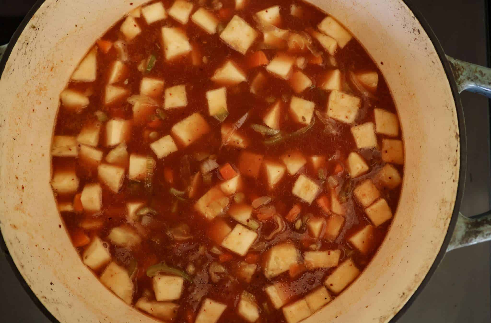 All ingredients for celeriac and lentil soup (except for balsamic vinegar and cilantro) are in a pot and ready to cook for 45 minutes