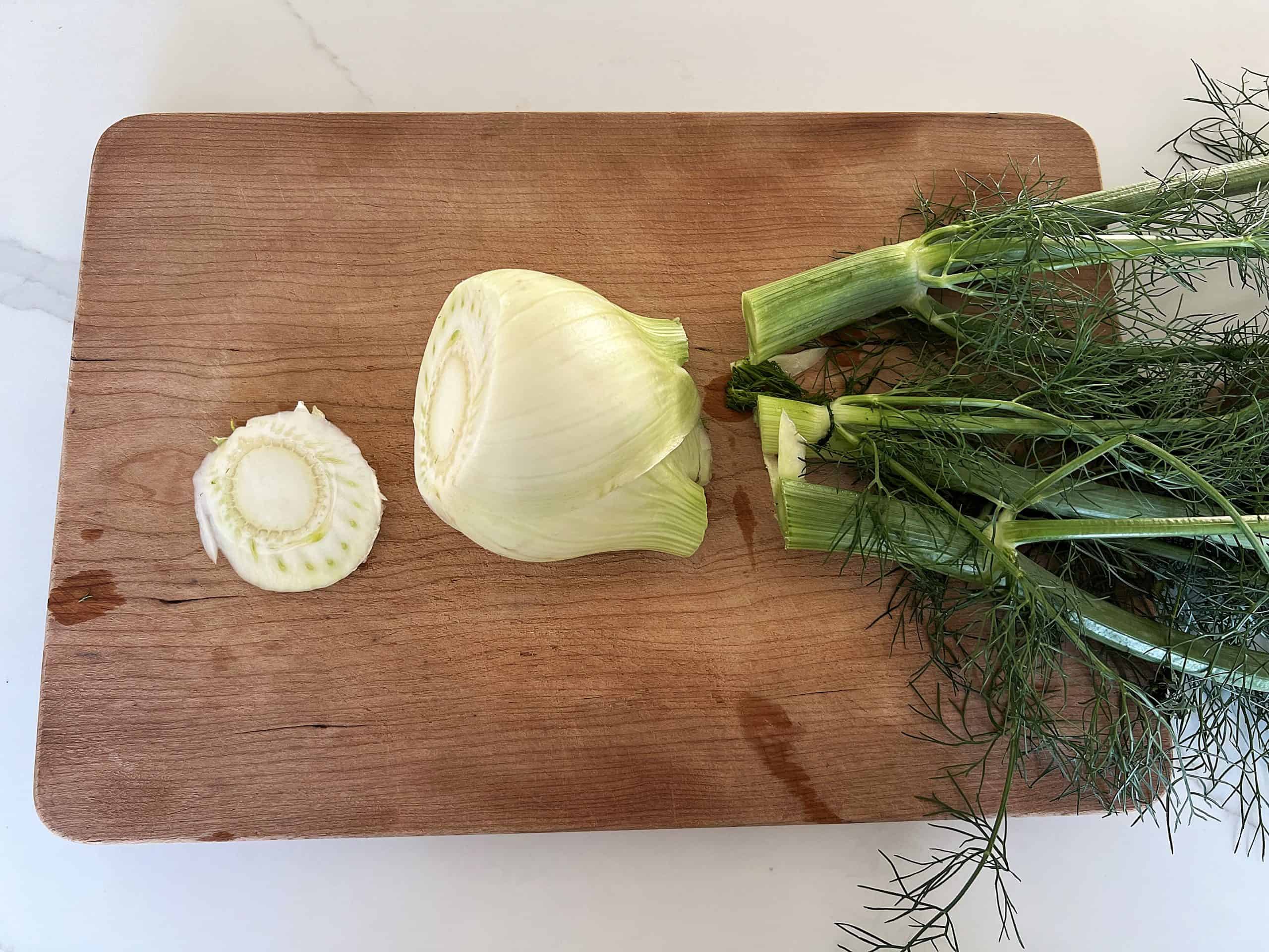 a fennel bulb on a cutting board with the tops and bottom removed