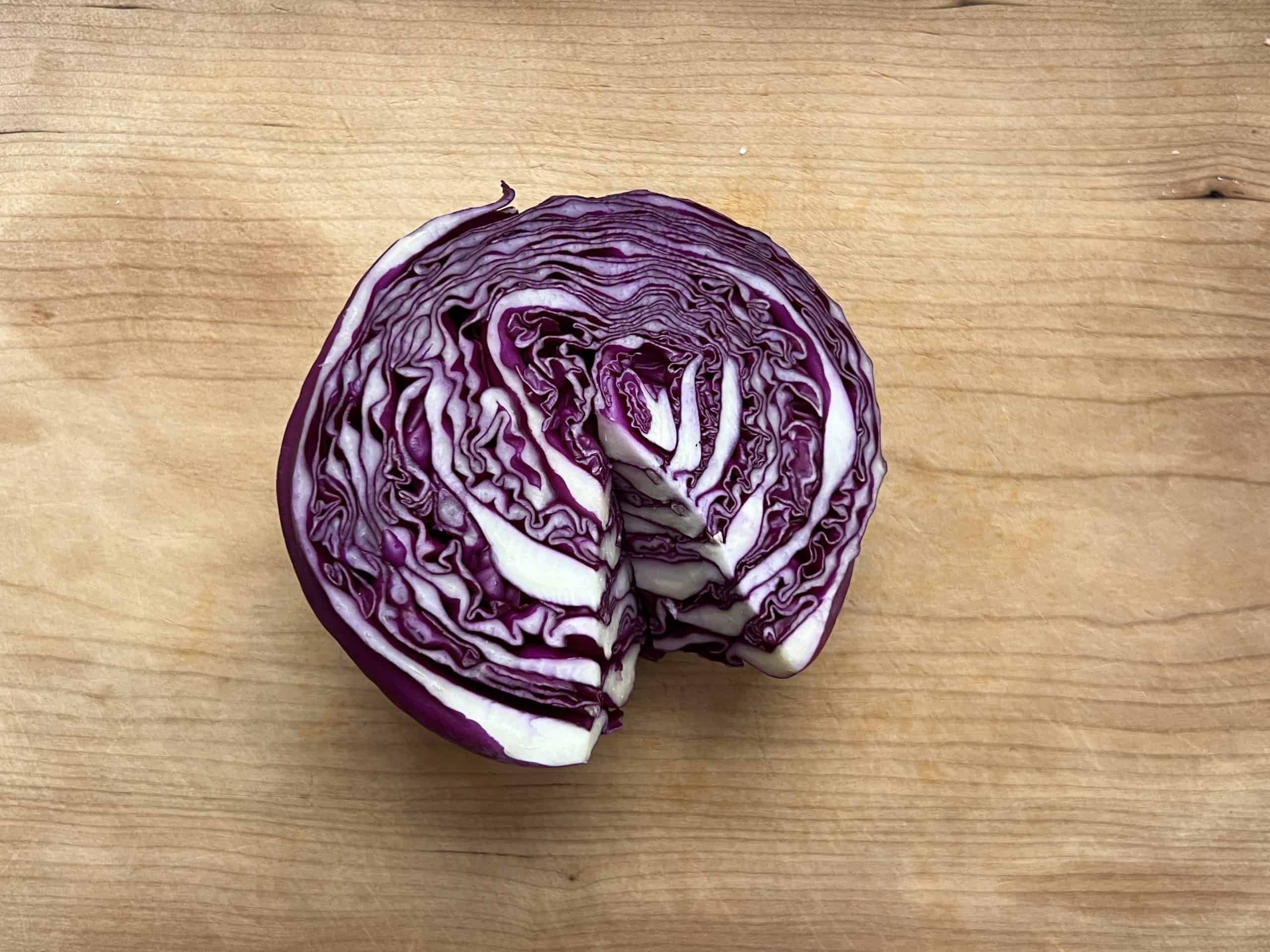 half a cored red cabbage on a cutting board