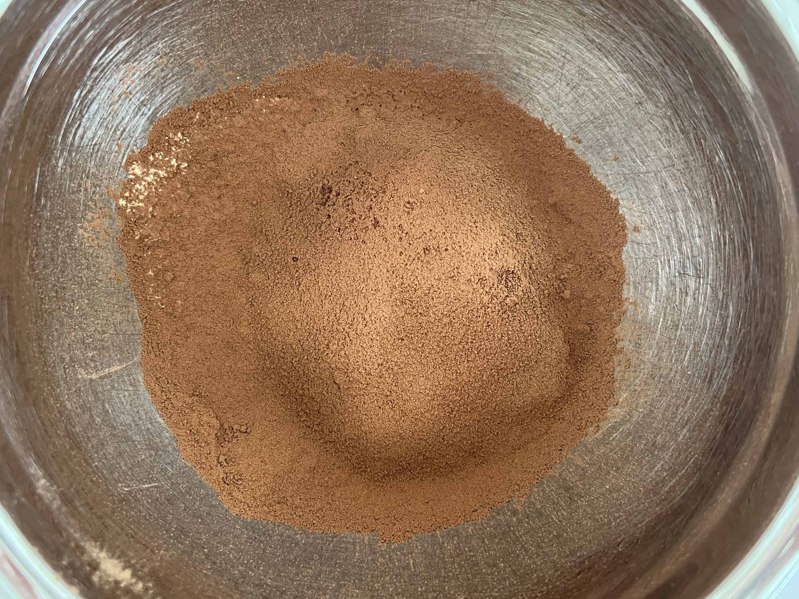 Bowl with dry ingredients for vegan gf chocolate chip cookies with cacao powder