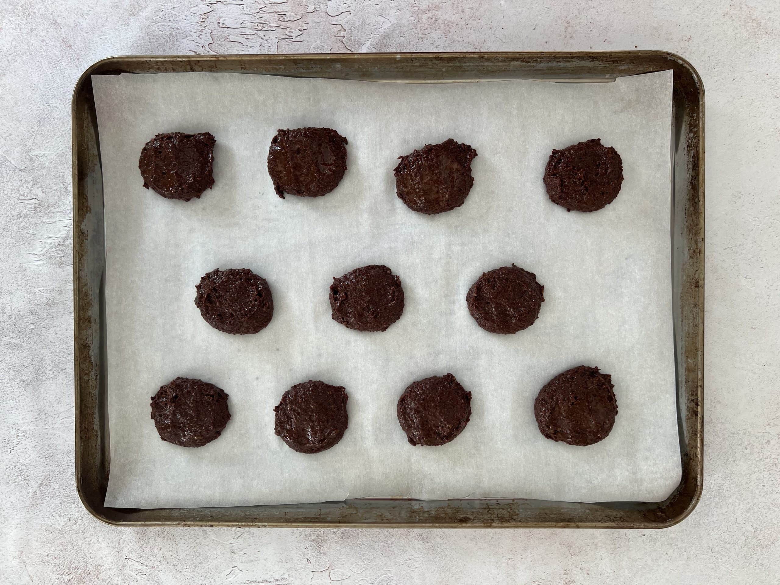 baking sheet with unbaked vegan gluten free chocolate chip cookies