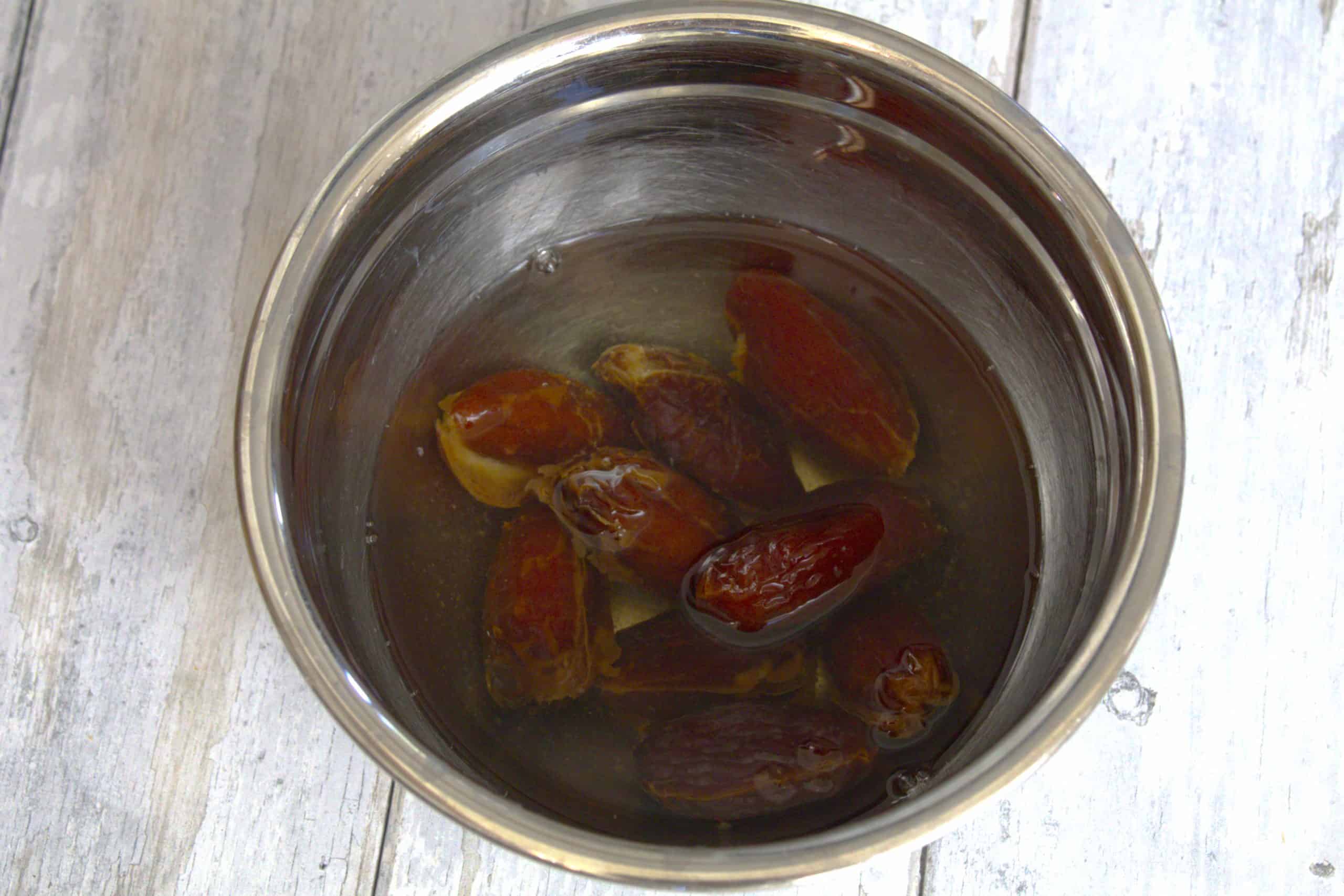 dates soaking in water in a bowl