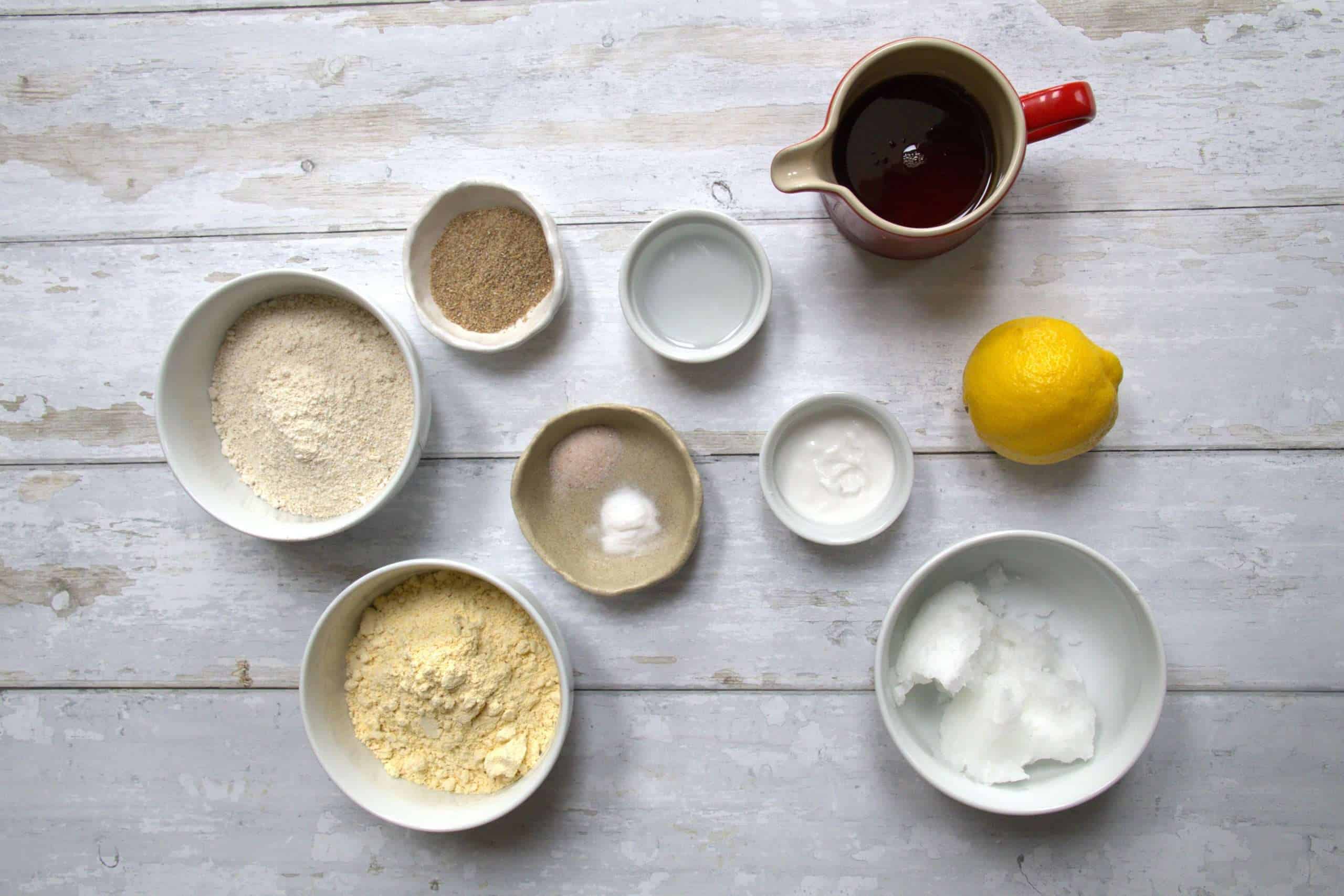 All the ingredients for gluten-free lemon cookies displayed on a white wooden background