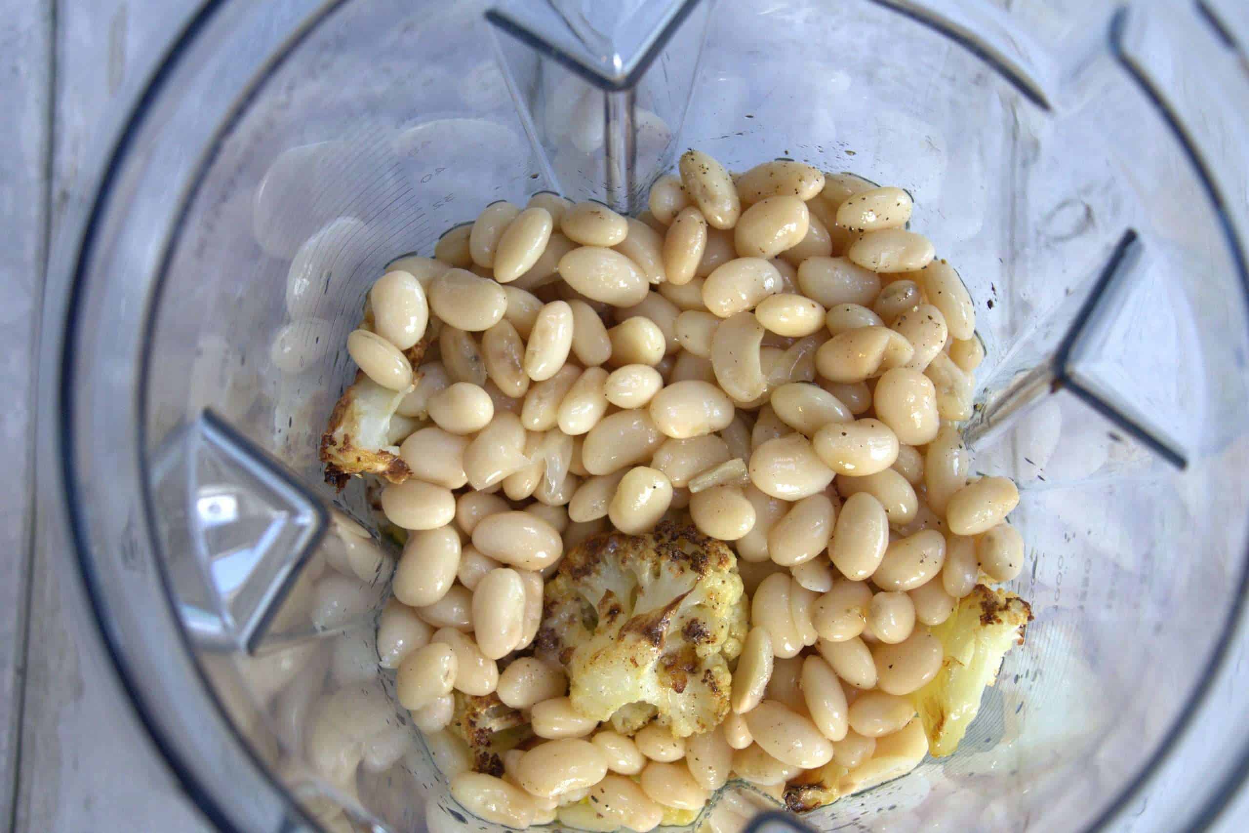 White beans and roasted cauliflower in a blender ready to be pureed