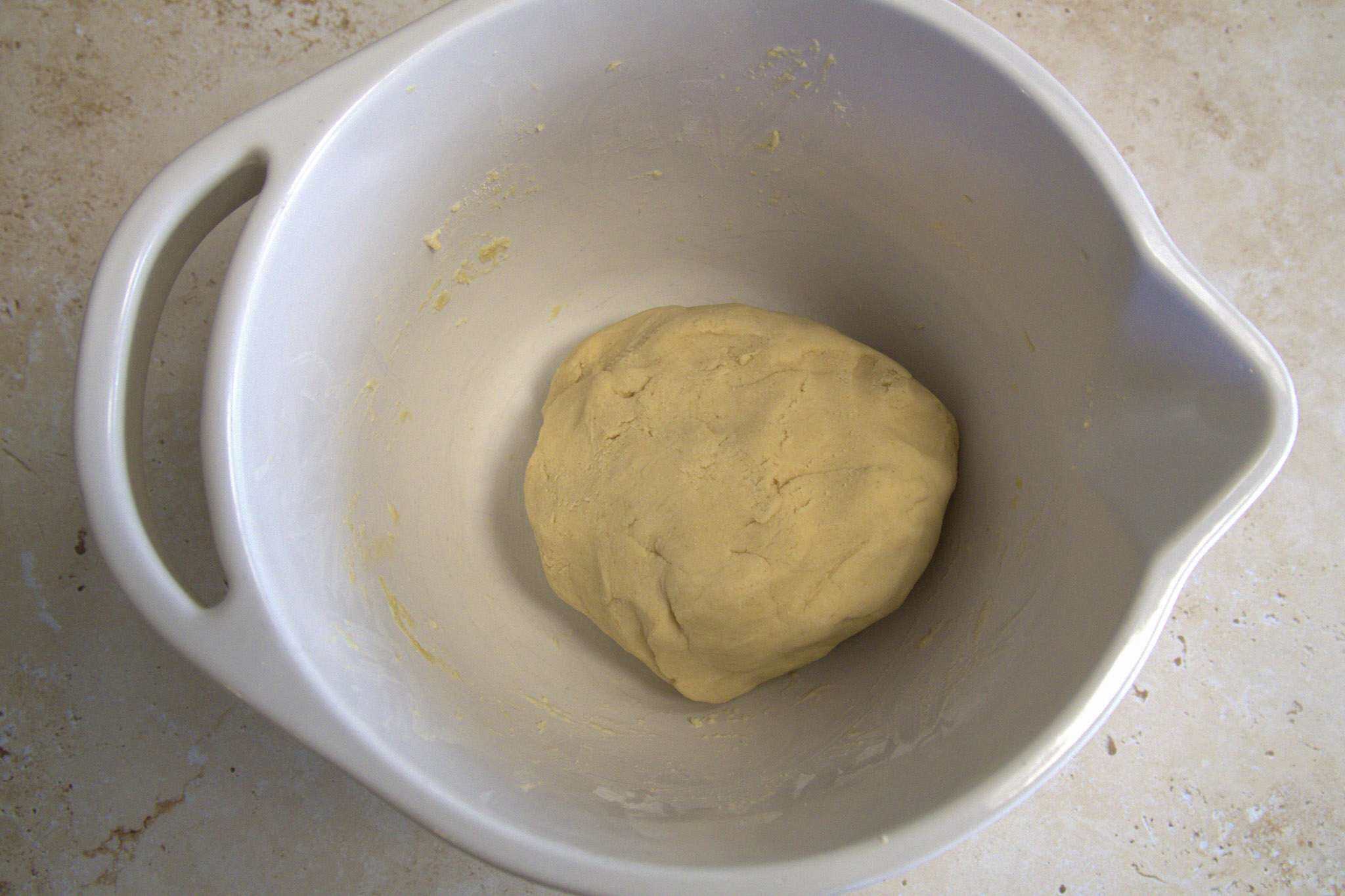 The blended dough for chickpea and cassava tortillas in a ball in a white bowl
