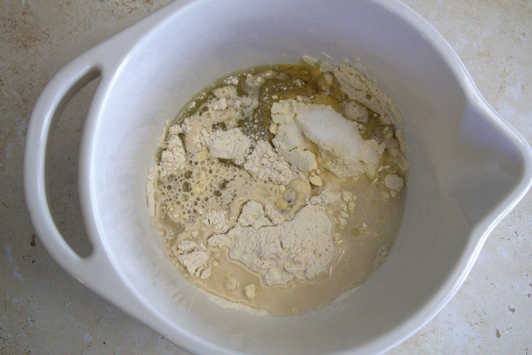 the ingredients for chickpea and cassava tortillas combined in a white bowl