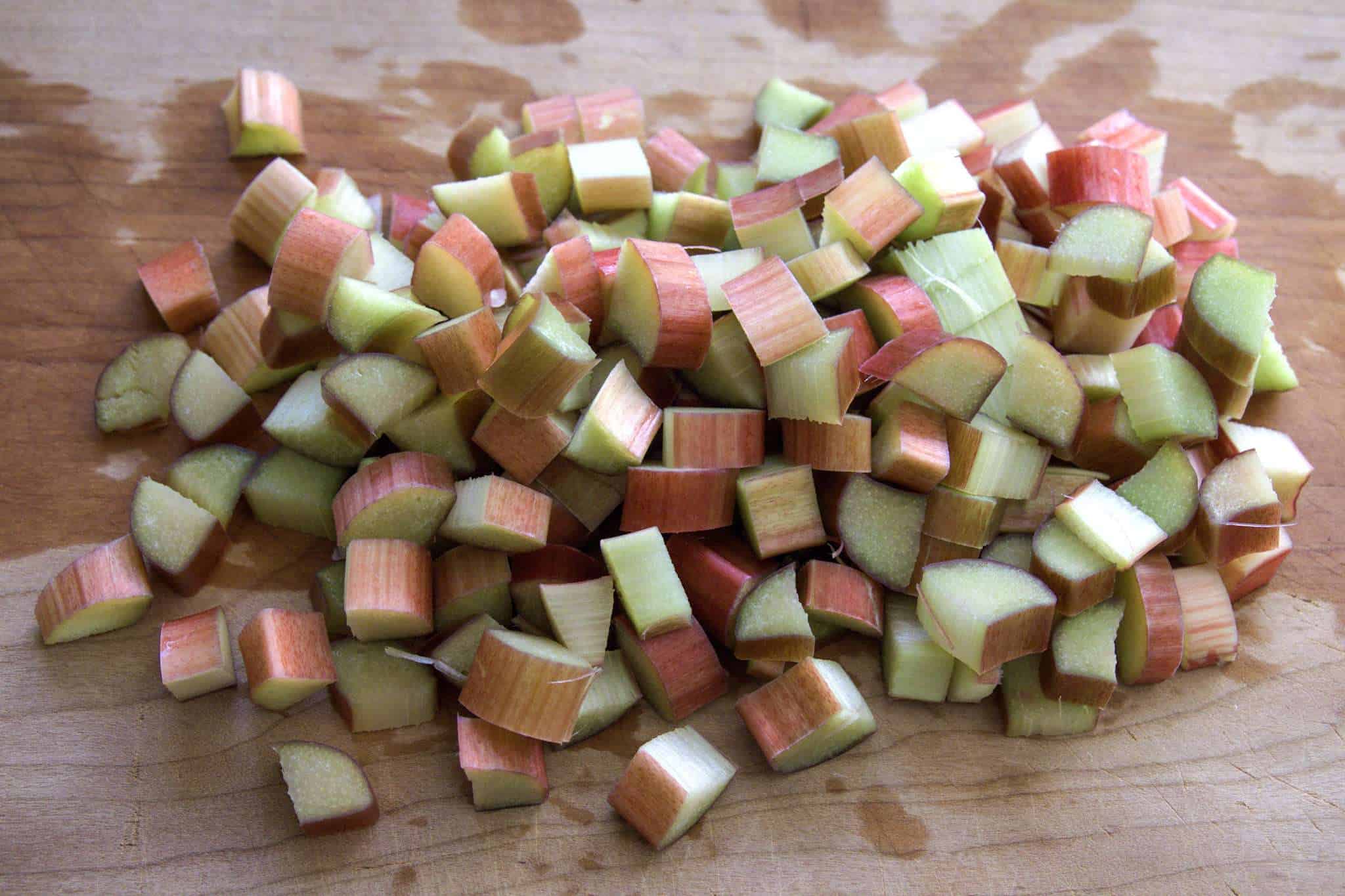 A cutting board with chopped rhubarb