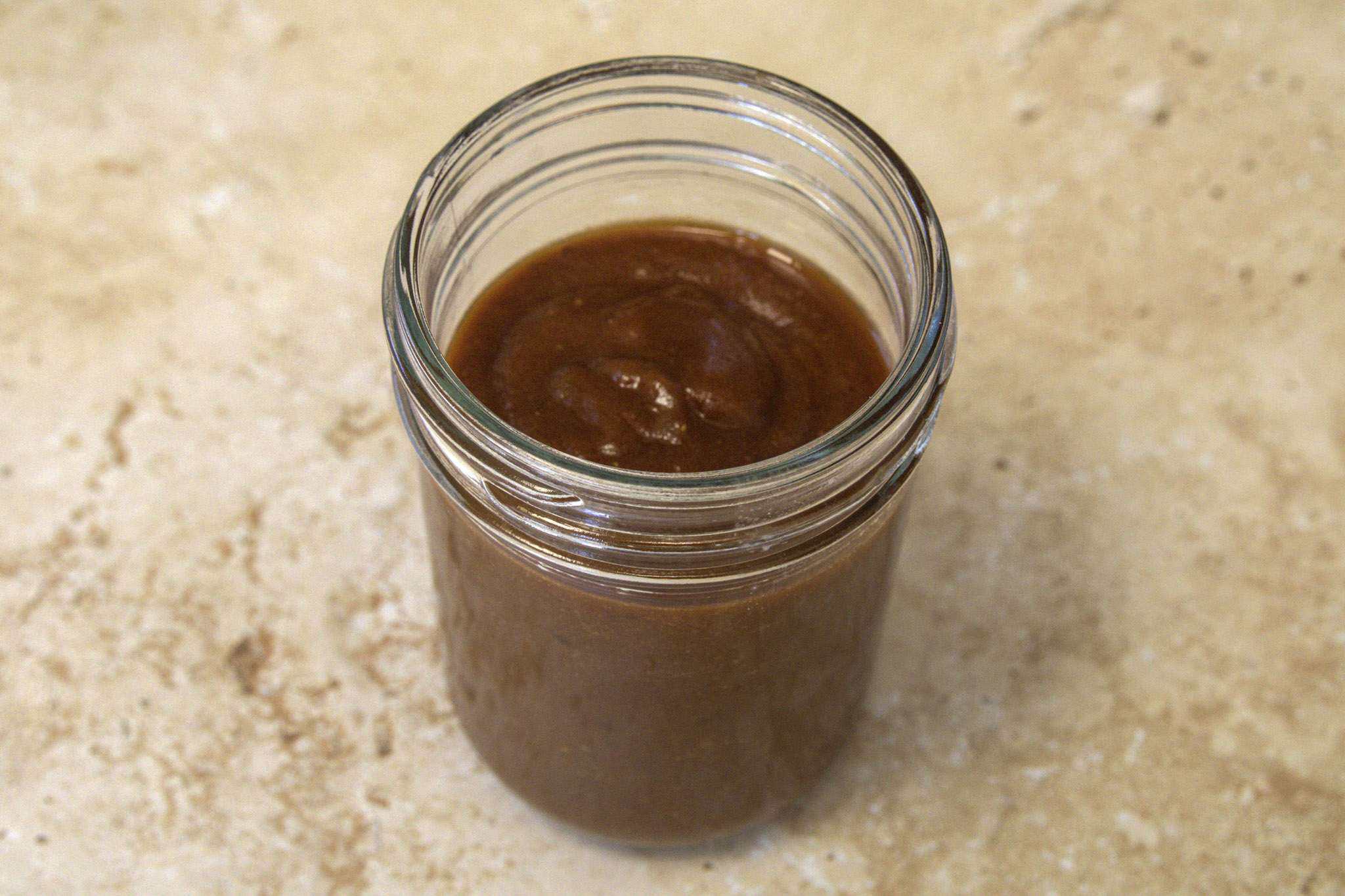 a jar filled with adobo inspired sauce