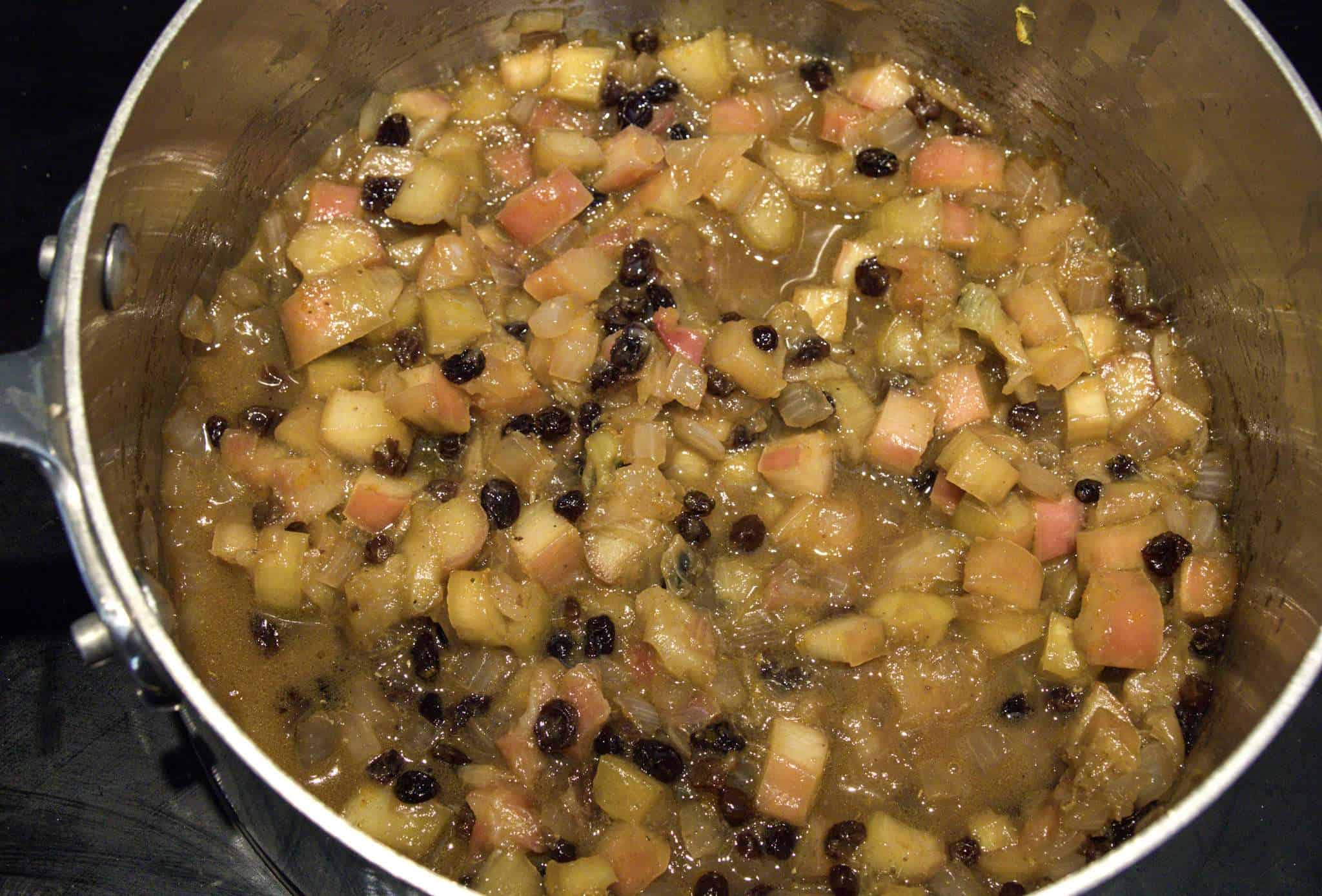 A pot with rhubarb chutney that has cooked and softened