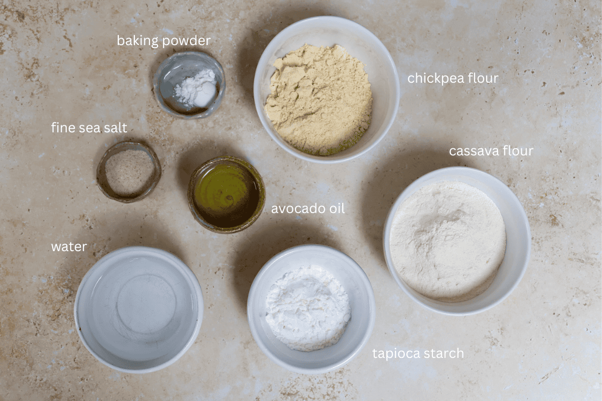 All ingredients for grain-free chickpea and cassava tortillas are displayed in small bowls and labeled