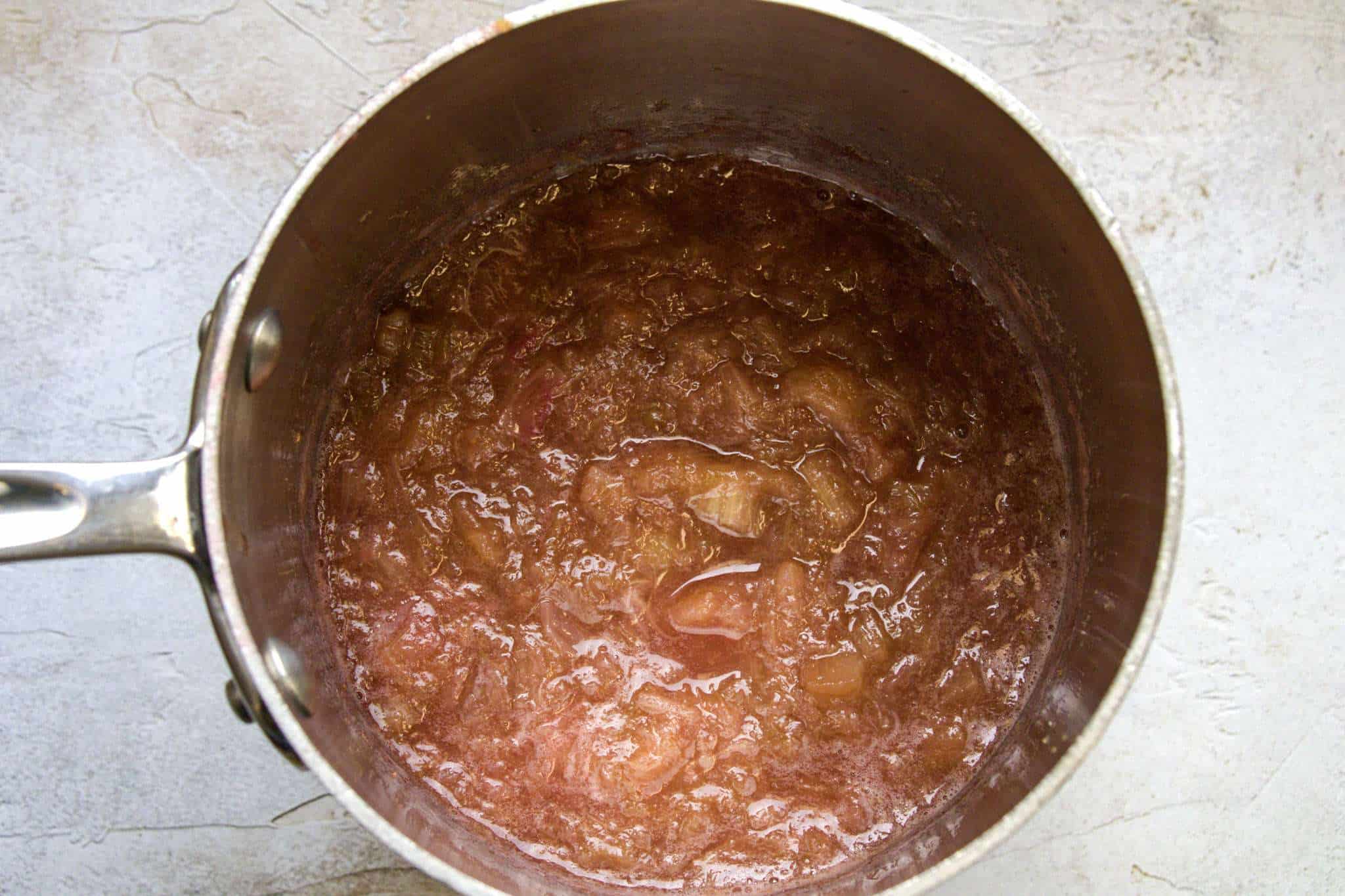 A small pot of cooked rhubarb compote