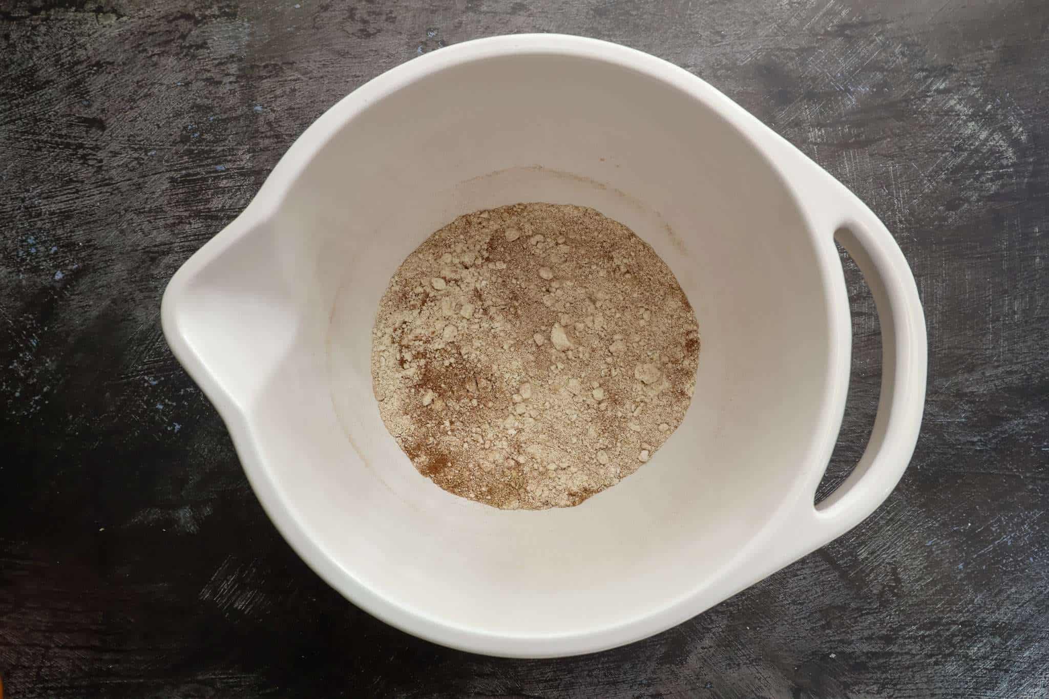 Dry ingredients for Soft and Fluffy Pumpkin Bars (with White Beans and a Healthy Twist) in a white mixing bowl