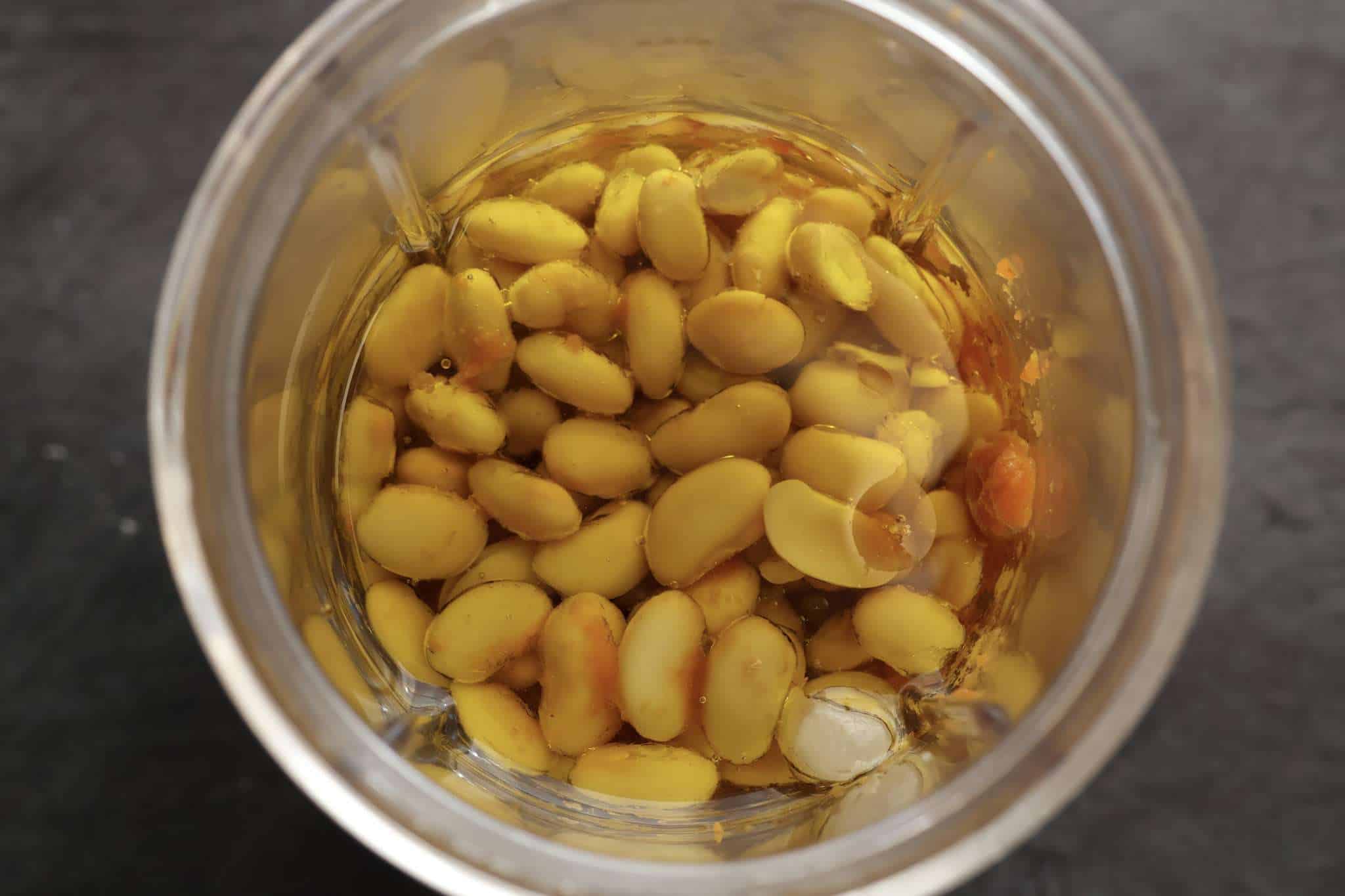 A small blender container with with the wet ingredients, including white beans, for Soft and Fluffy Pumpkin Bars (with White Beans and a Healthy Twist) ready to be blended