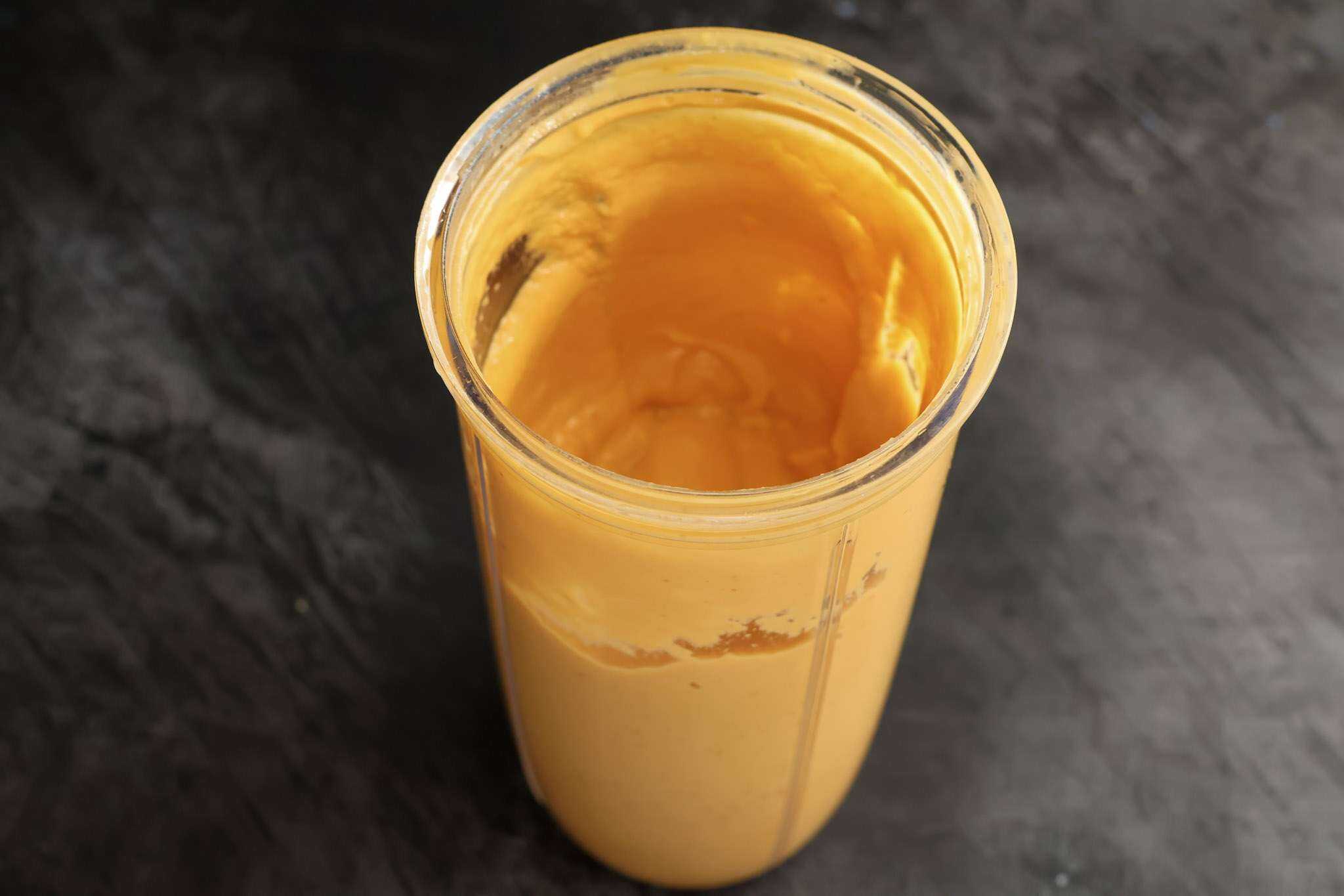 A small blender container with the blended wet ingredients for Soft and Fluffy Pumpkin Bars (with White Beans and a Healthy Twist)