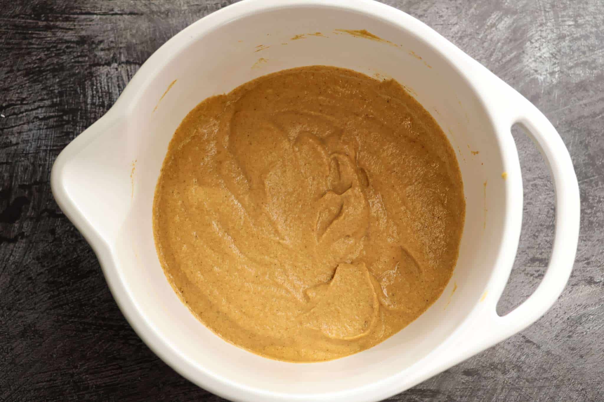 A white mixing bowl with the batter for Soft and Fluffy Pumpkin Bars (with White Beans and a Healthy Twist)