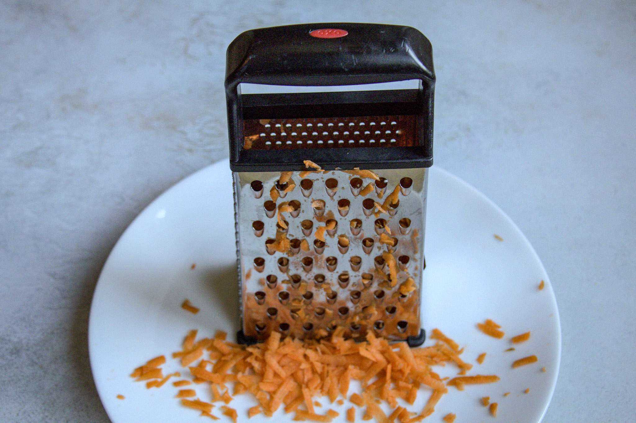 A boxer grated on a plate with grated carrots