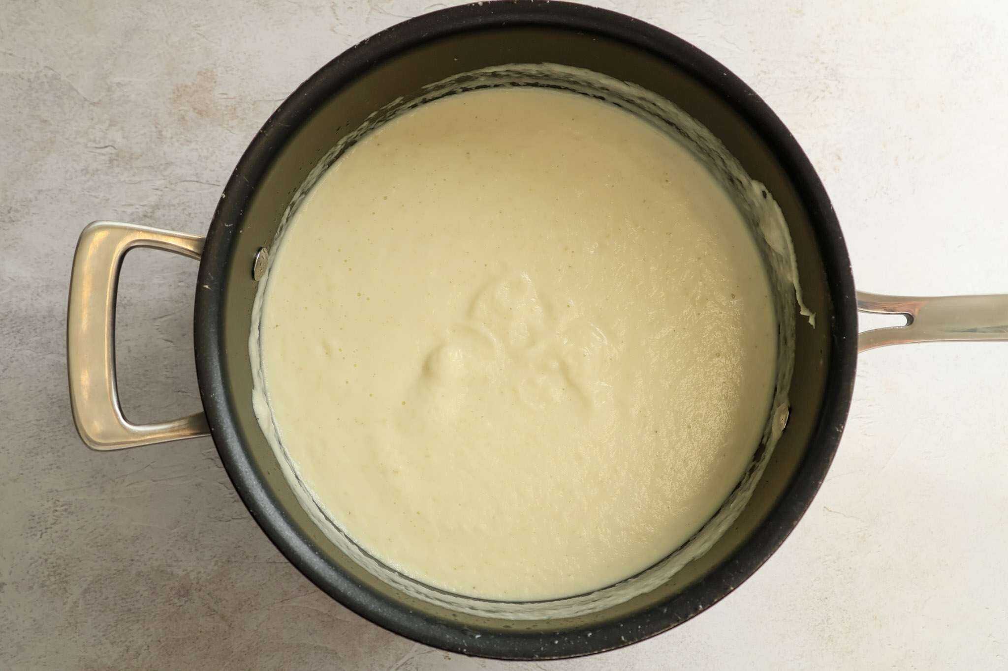 Pureed spiced kohlrabi, fennel and apple soup in a pot