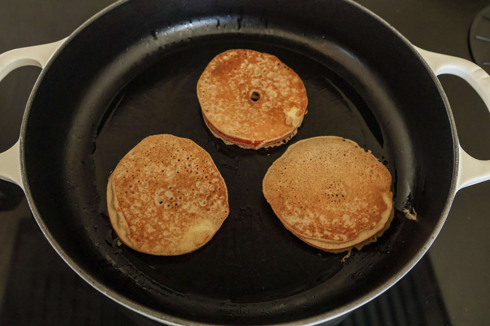 3 golden apfelringe in a skillet