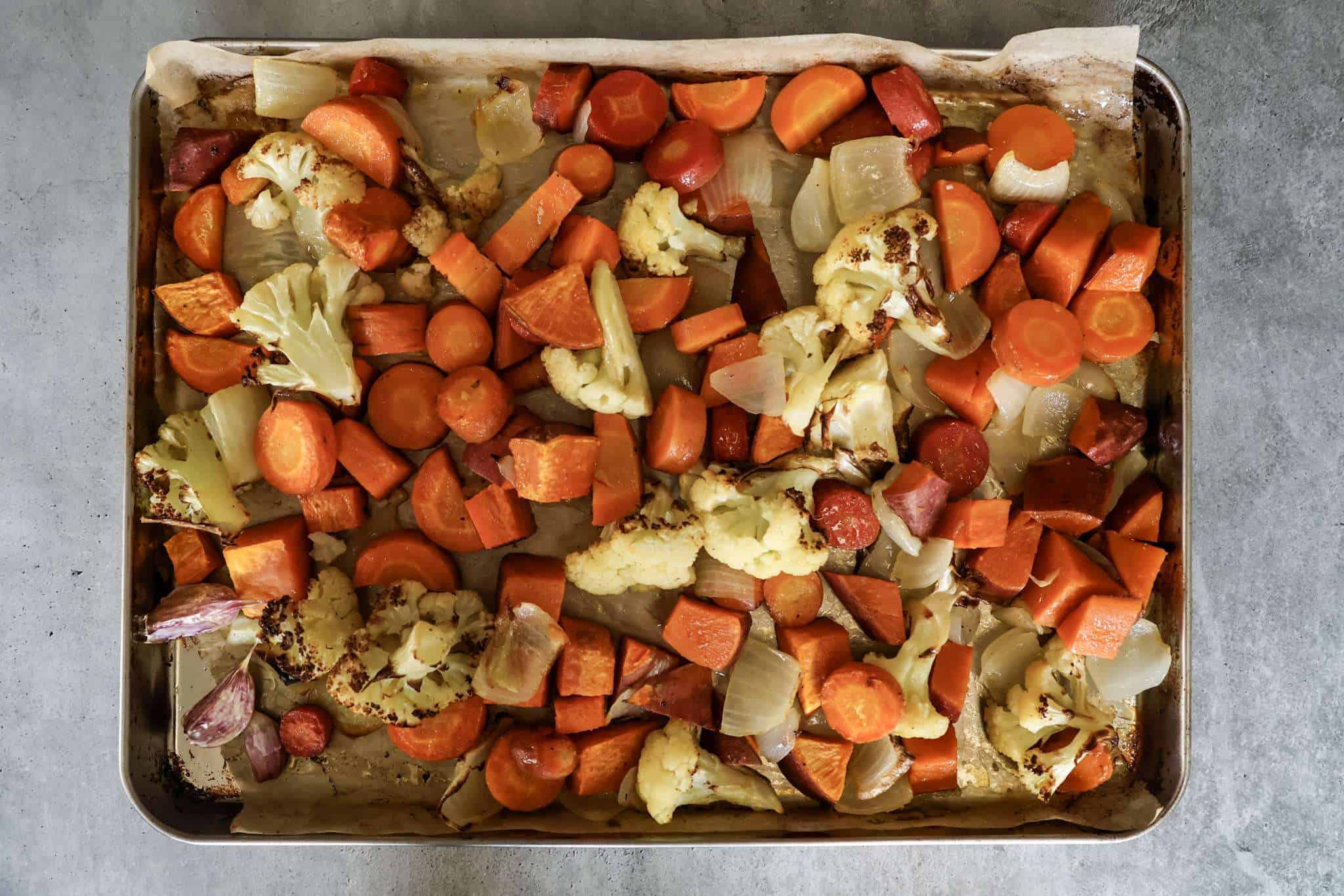 a baking sheet with roasted vegetables for creamy winter vegetable soup