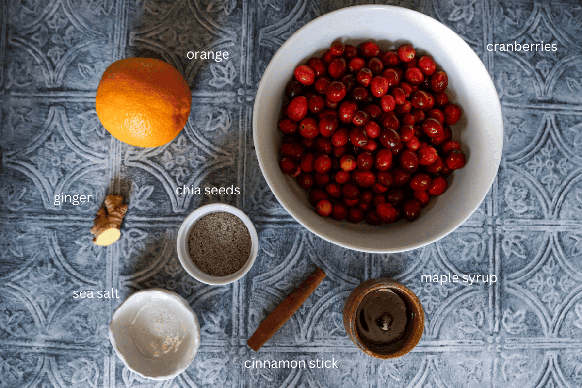 All ingredients for cranberry chia jam with orange and ginger are displayed and labeled