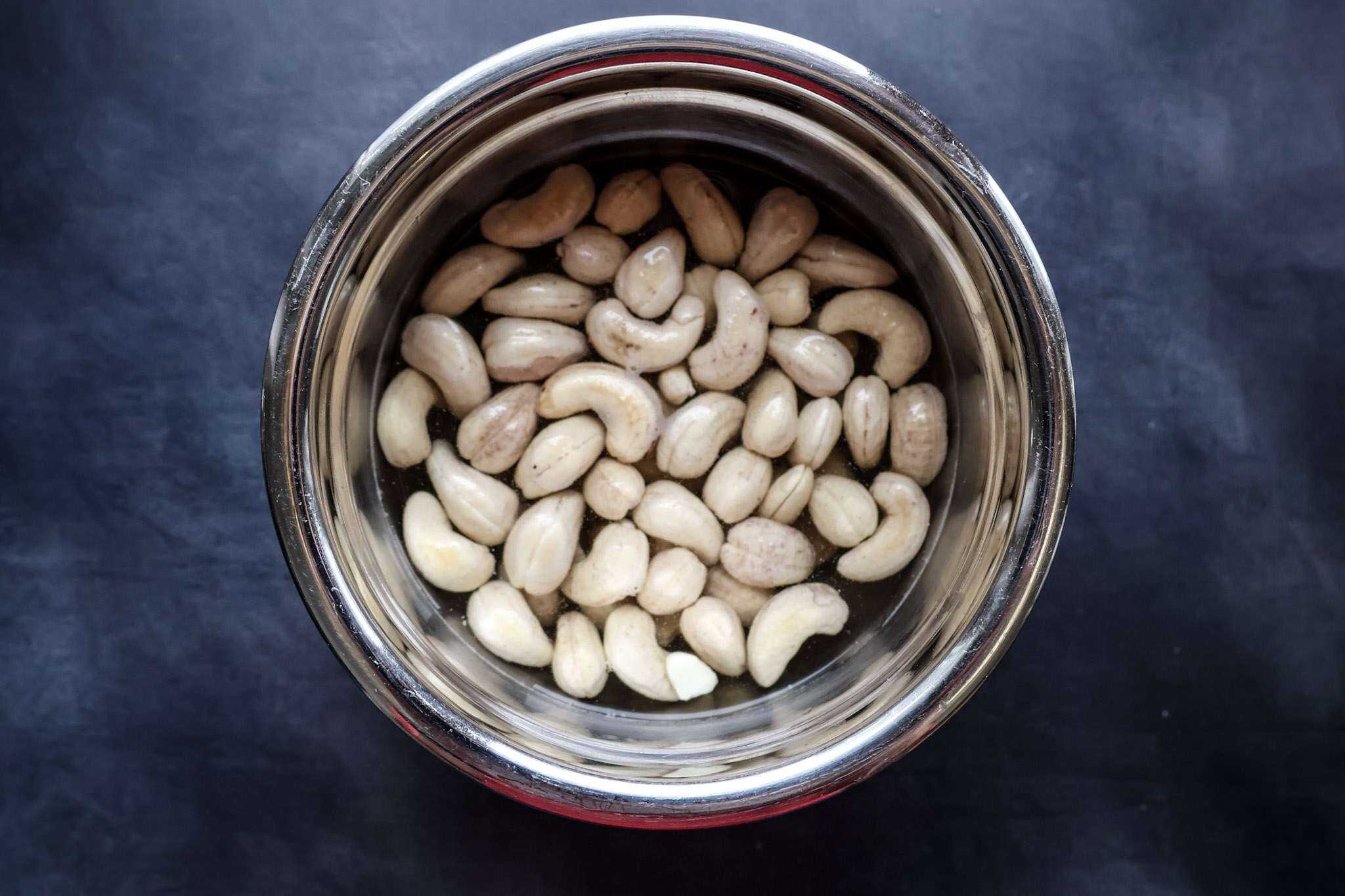 cashews soaking in a small metal bowl