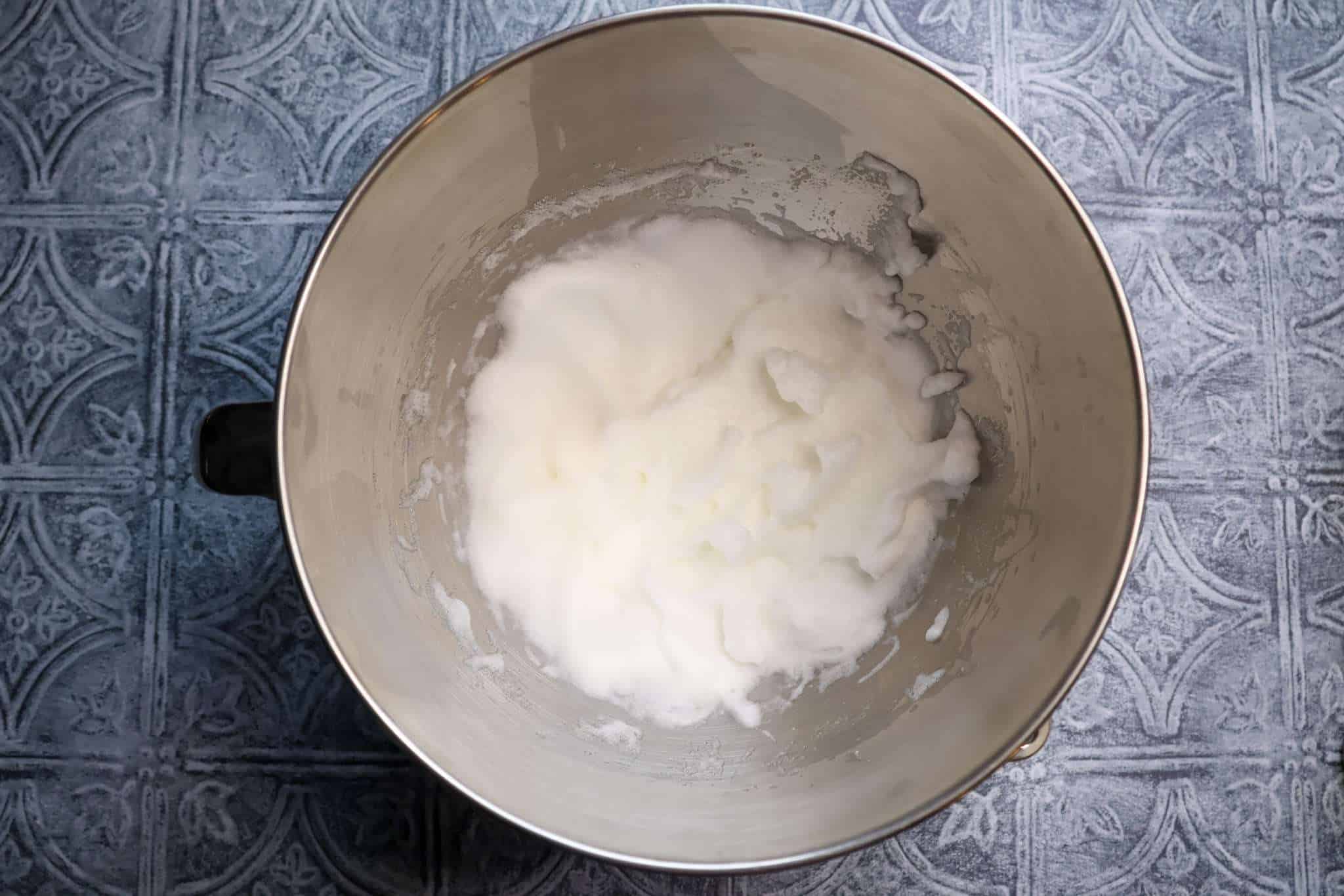 A metal bowl with whipped egg whites