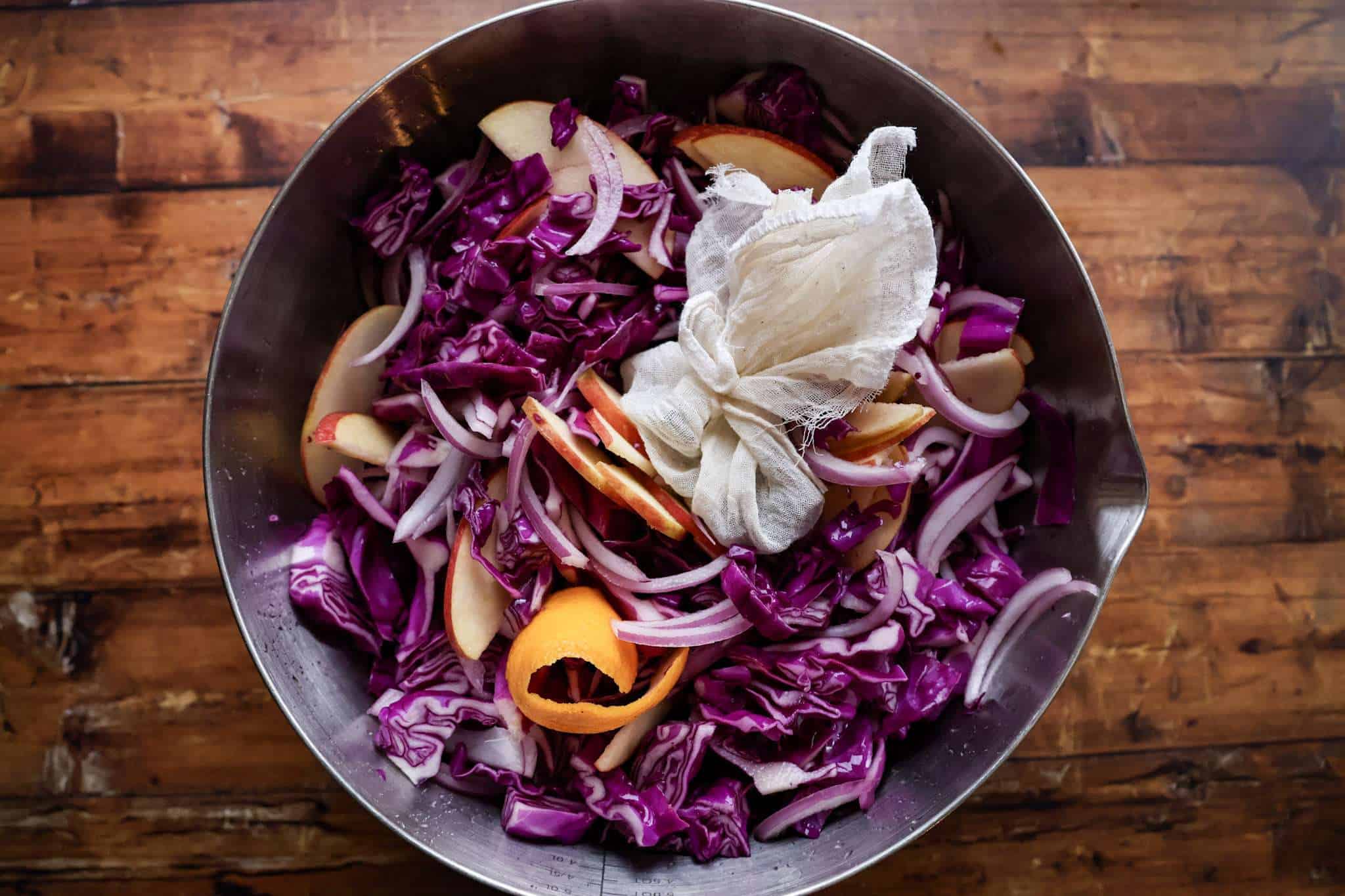 A large bowl filled with ingredients for red cabbage ready to rest overnigth
