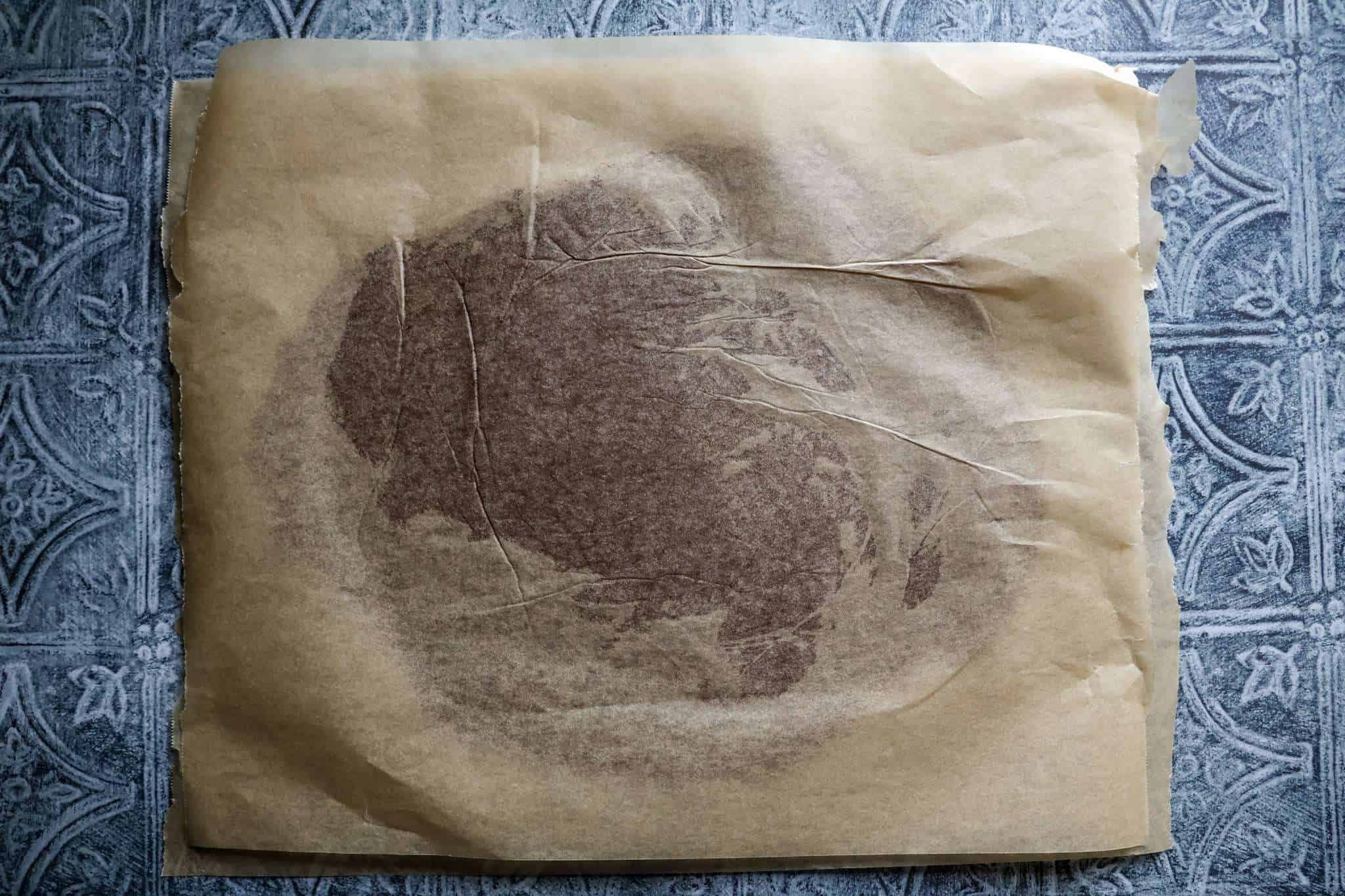 Rolled out dough for healthier zimtsterne between parchmen paper