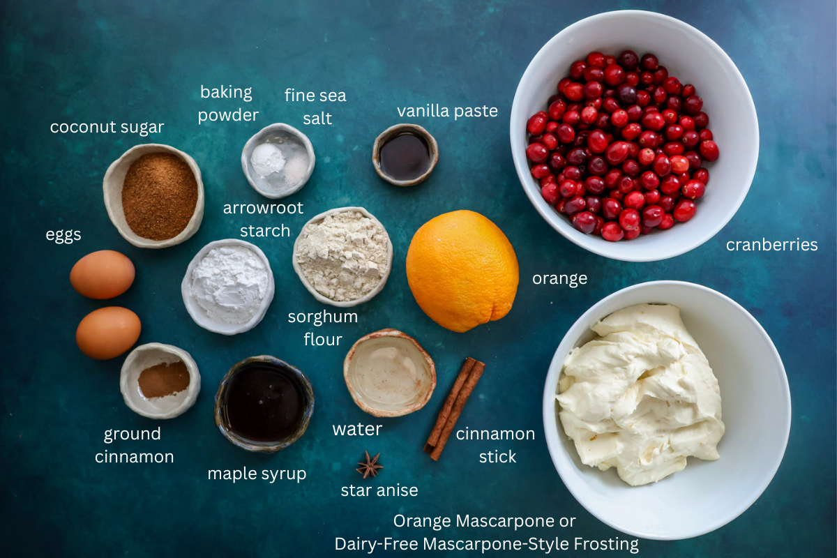 all ingredients for cranberry orange tiramisu pie are labeled and displayed on a dark tealcolored background