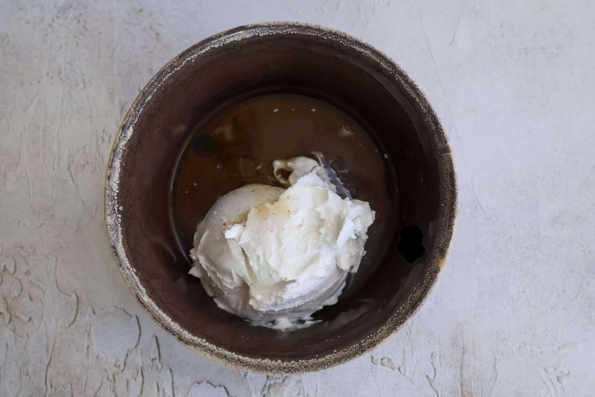 A small brown bowl with the ingredients for easy coconut creme fraiche