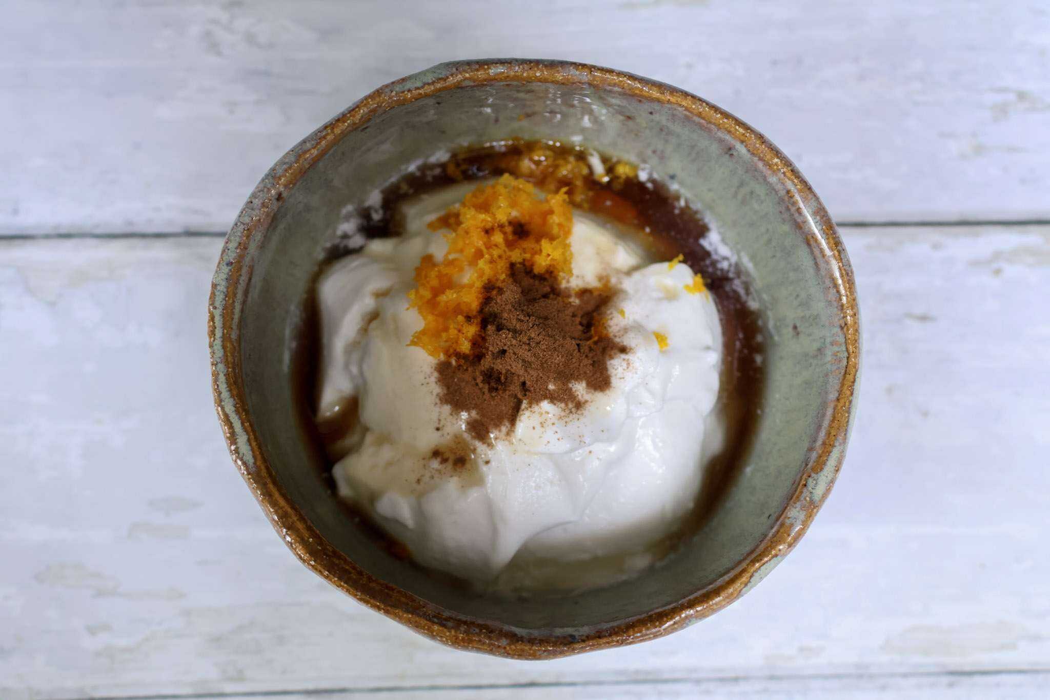 All ingredients for yogurt filling for carrot cake crepes in a bowl