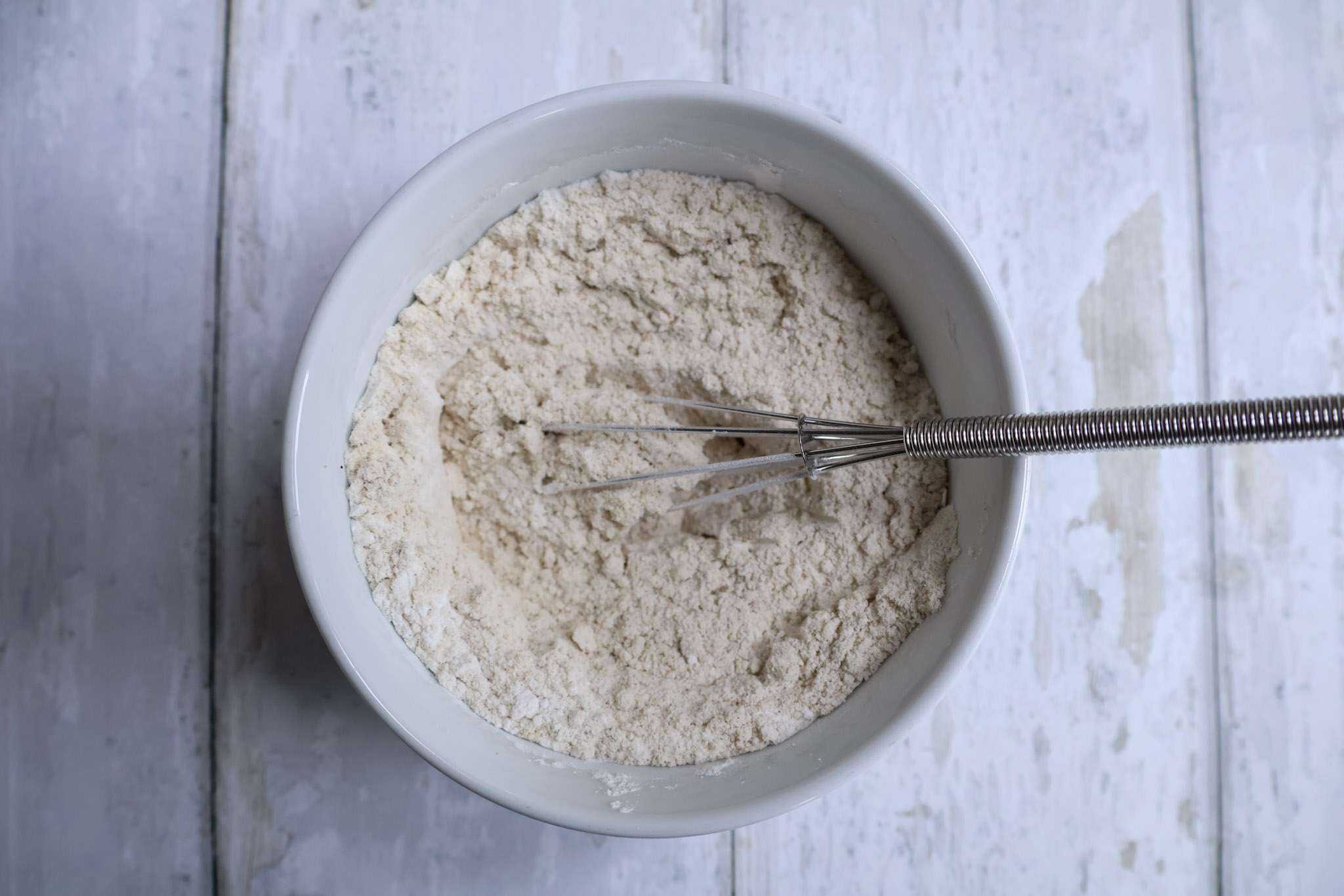 dry ingredients for gluten-free crepes in a small white bowl