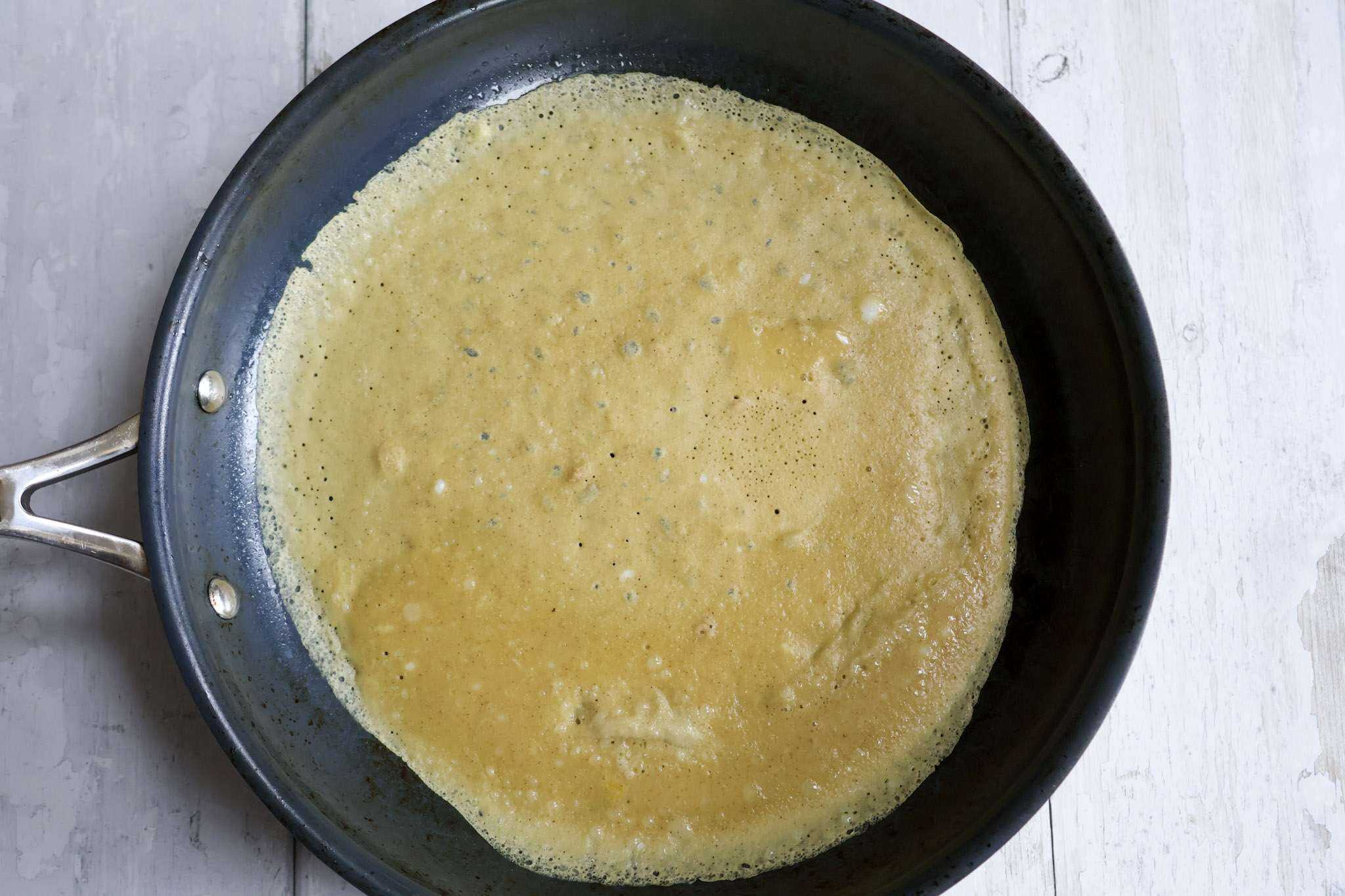 light and tender gluten-free crepes cooking in a pan