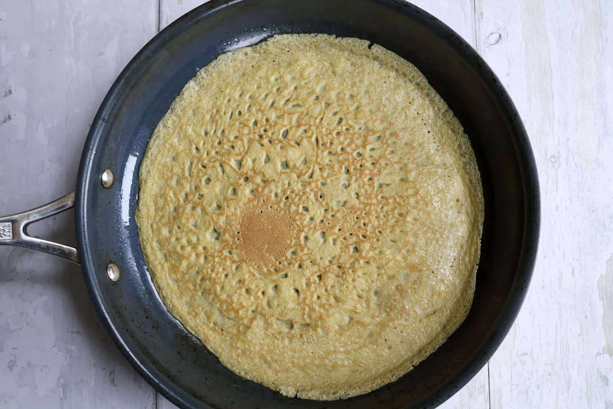 light and tender gluten-free crepes cooking in a pan