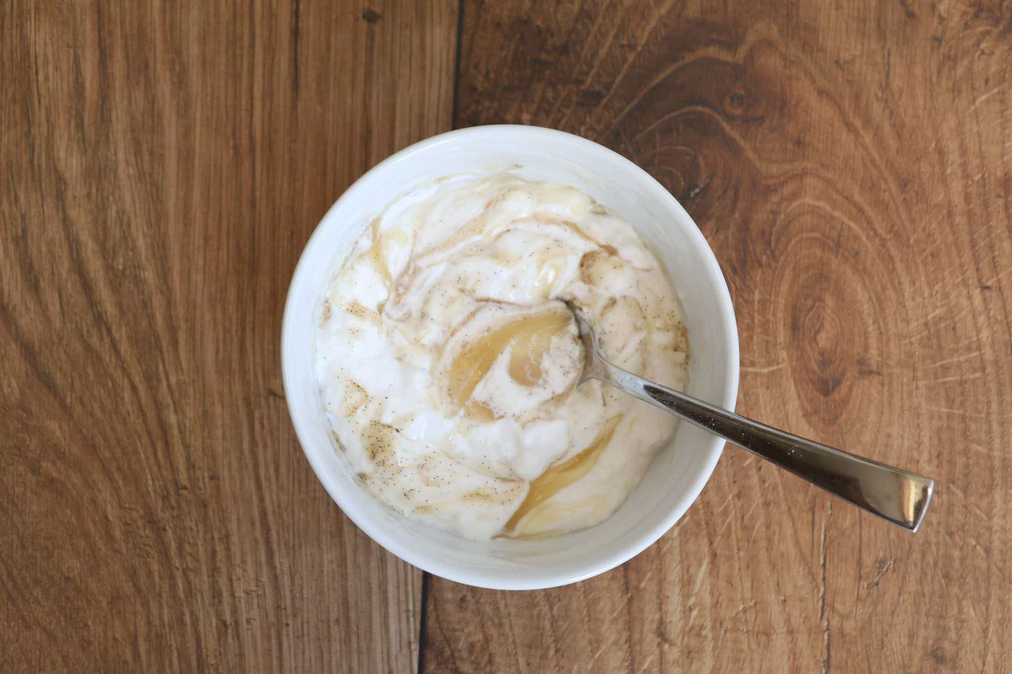 a small white bowl with honeyed coconut yogurt
