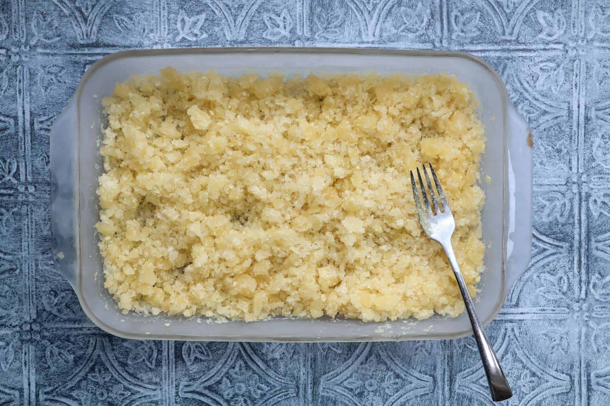 A clear casserole dish with citrus olive oil granita