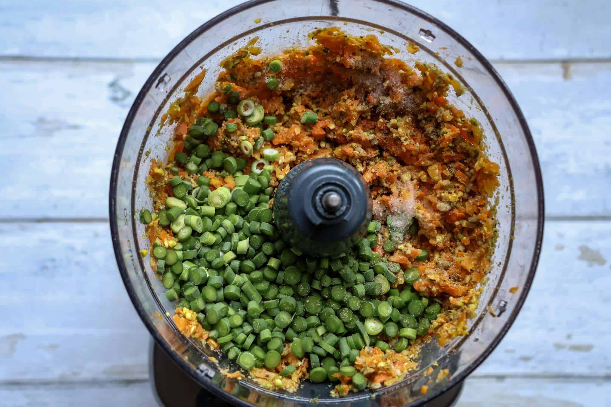 All Ingredients for carrot garlic scape pesto in a blender