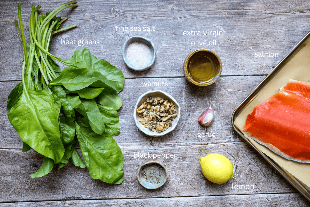 all ingredients for slow roasted salmon with beet green gremolata are displayed on a wooden surface and labeled