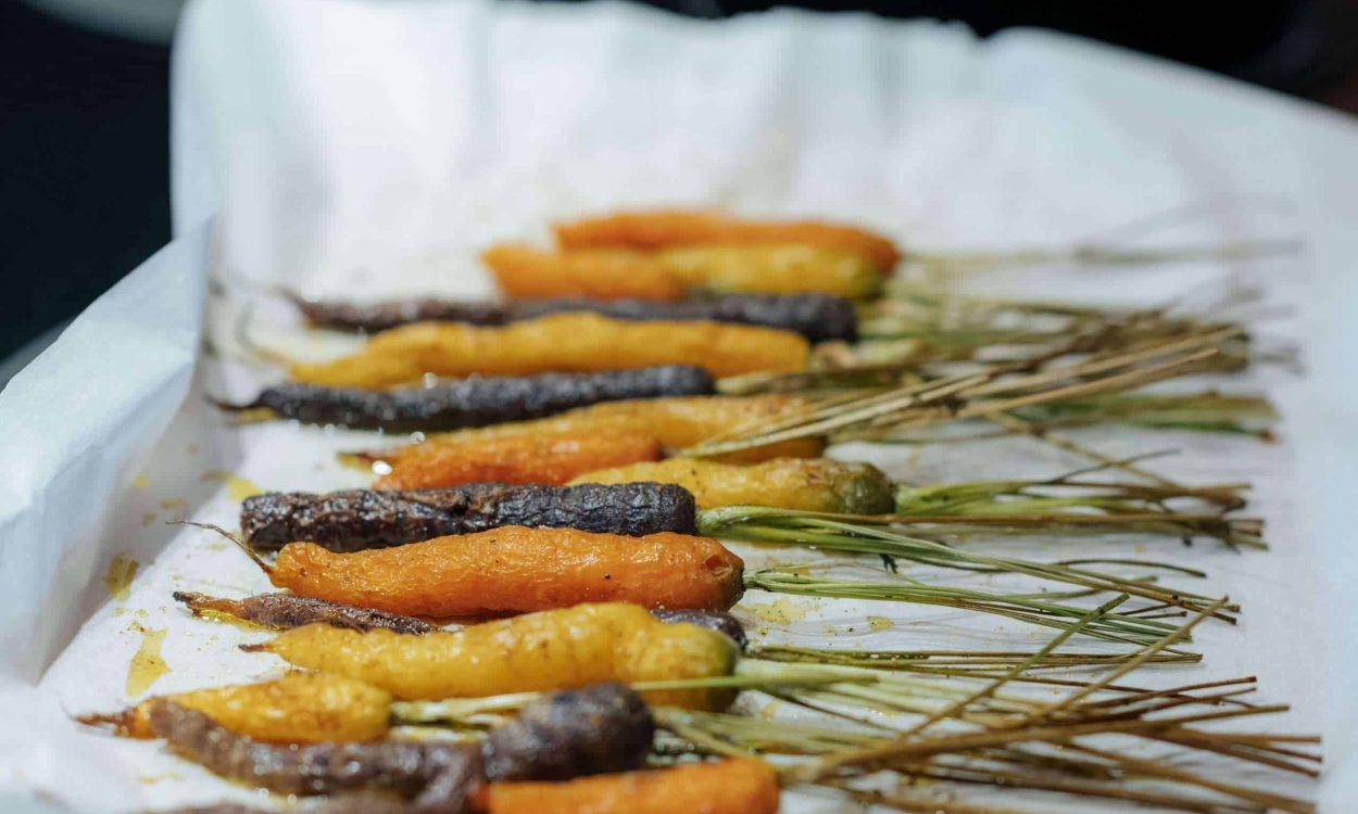 A baking sheet with colorful roasted carrots