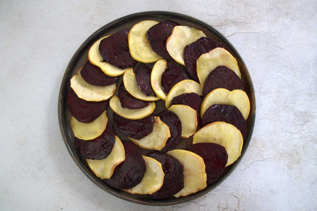 plate of sliced beets and apples arranged in a circular pattern